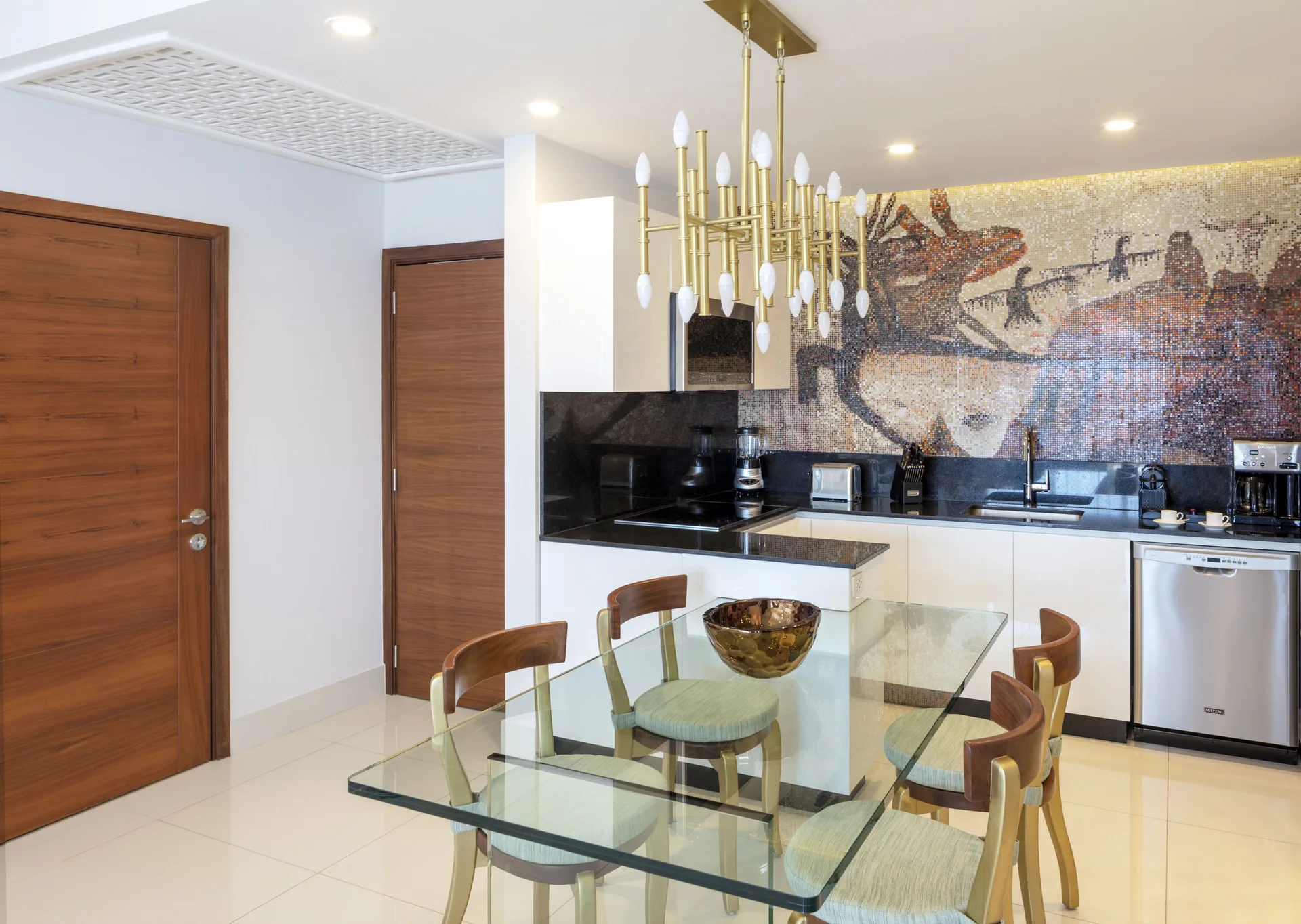 One Bedroom Suite kitchen with glass dining table at Garza Blanca Los Cabos.
