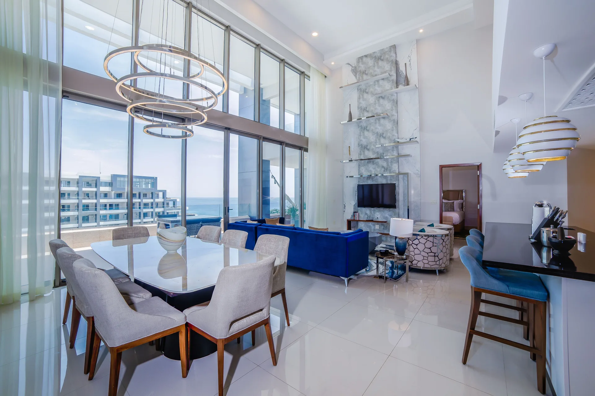 Double-height loft living and dining area with ocean views at Garza Blanca Los Cabos.