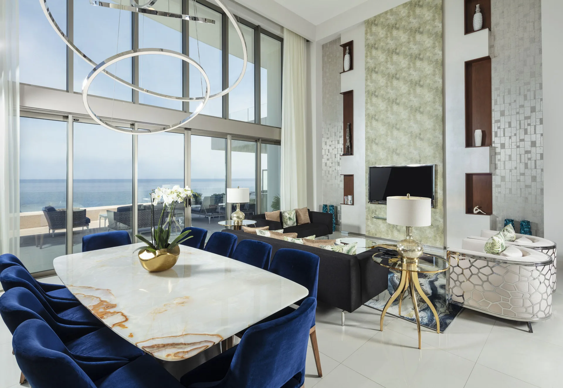 Penthouse dining and living room with ocean-facing windows at Garza Blanca Los Cabos.