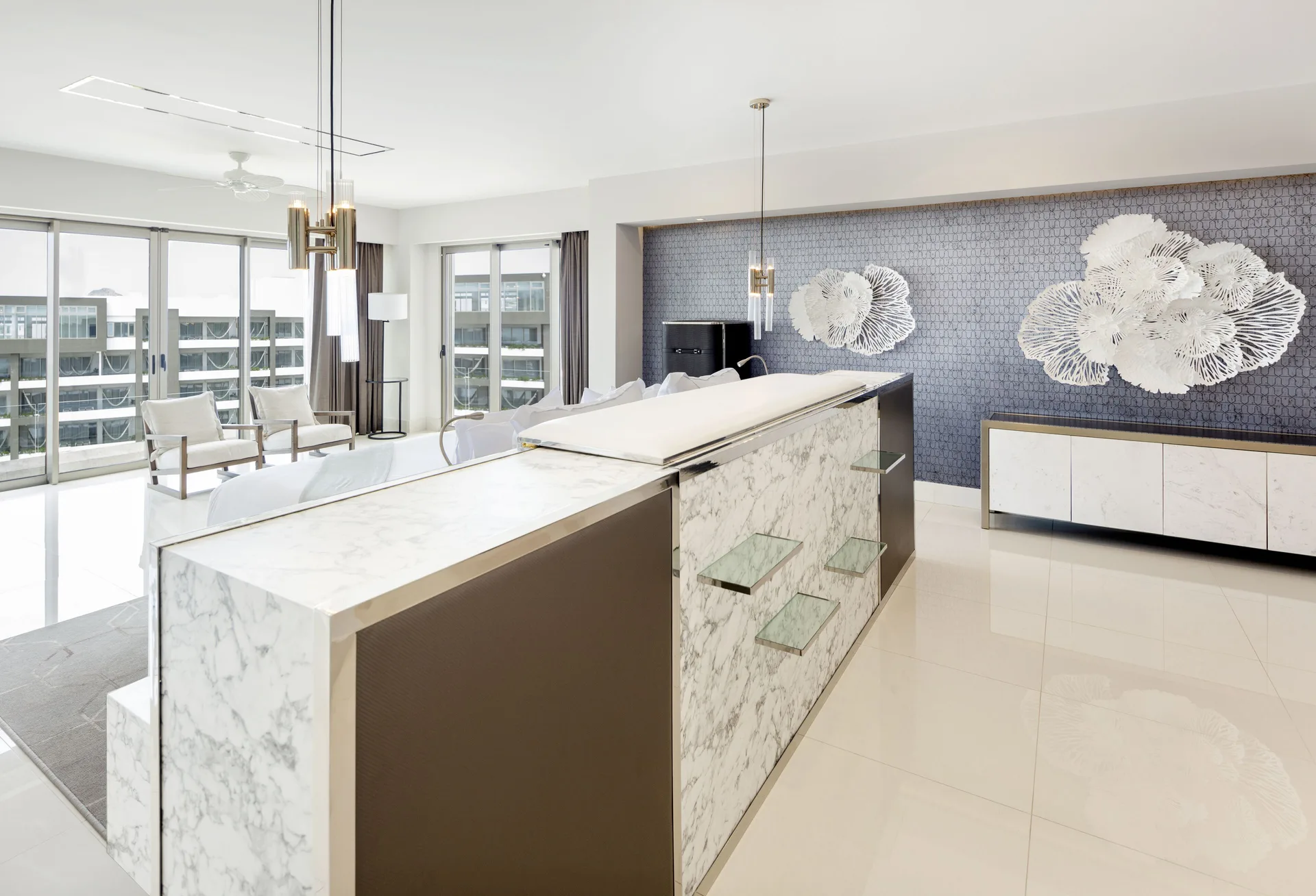 Penthouse living area with marble bar and balcony doors at Garza Blanca Los Cabos.