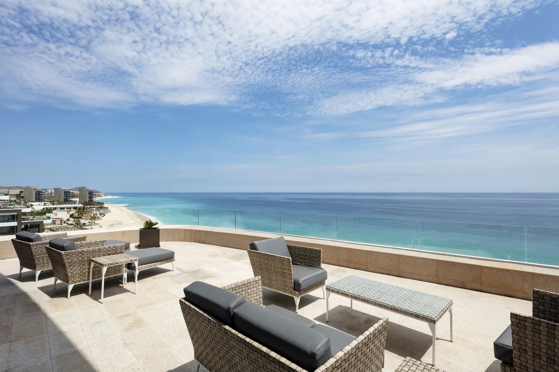Oceanfront penthouse terrace with lounge seating at Garza Blanca Los Cabos.