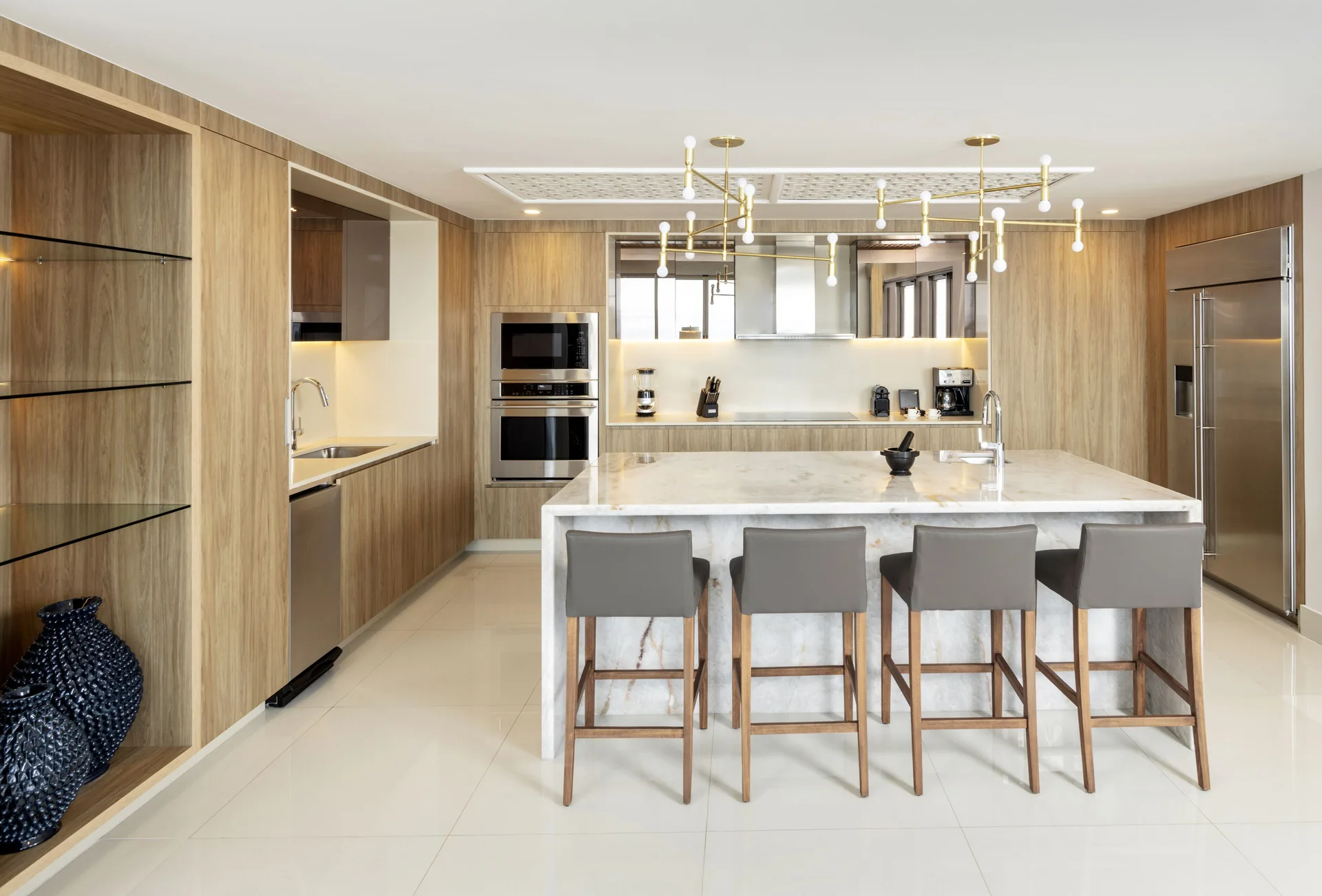 Oceanfront penthouse kitchen with island seating at Garza Blanca Los Cabos.