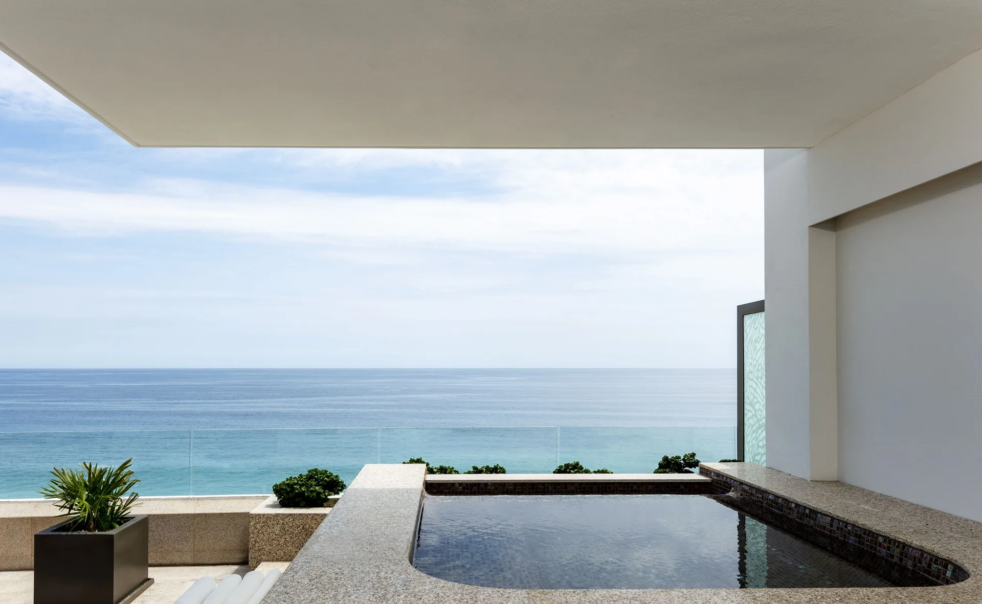 Oceanfront penthouse plunge pool terrace at Garza Blanca Los Cabos overlooking the sea.