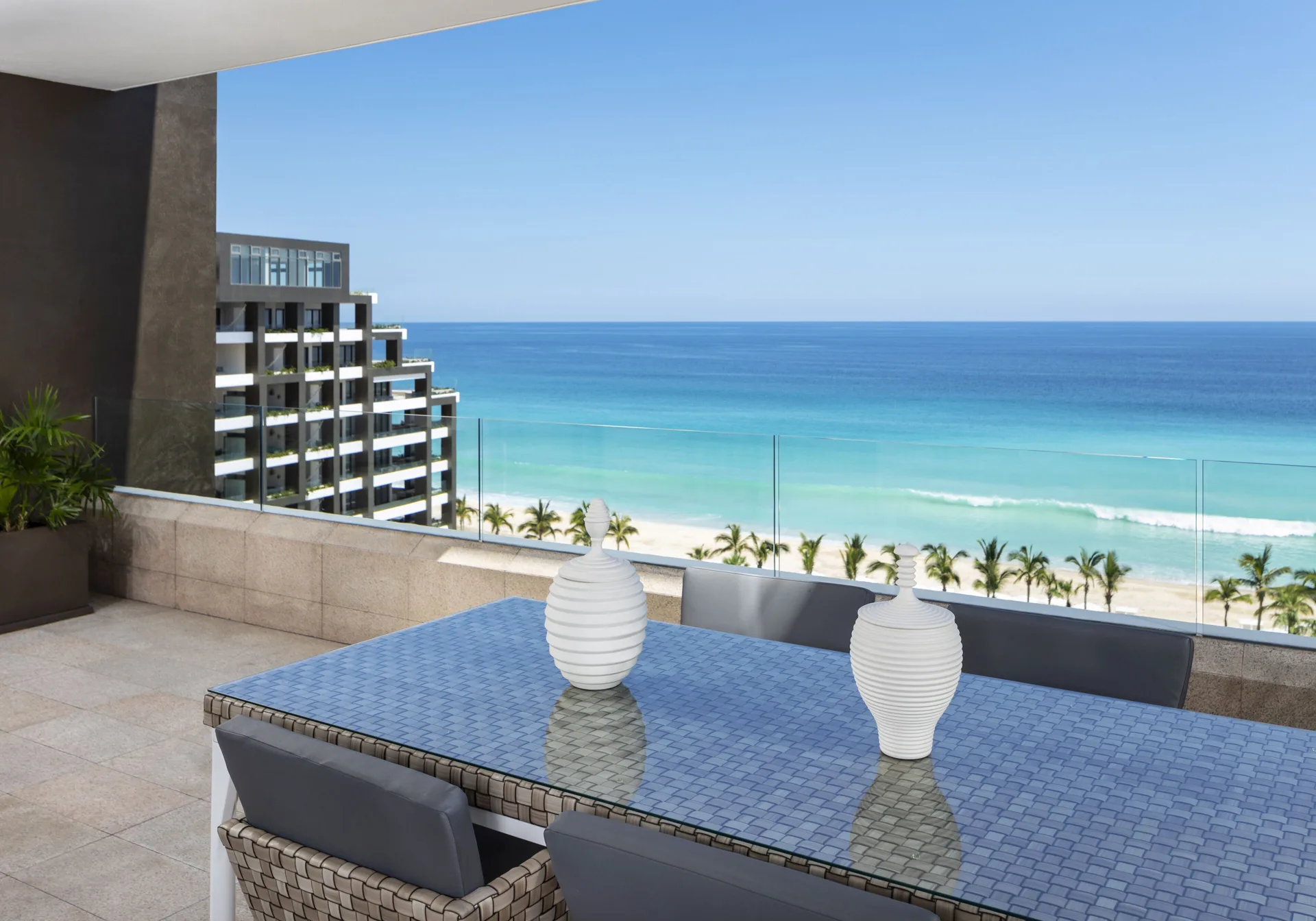 Oceanfront penthouse terrace dining table at Garza Blanca Los Cabos overlooking the beach.