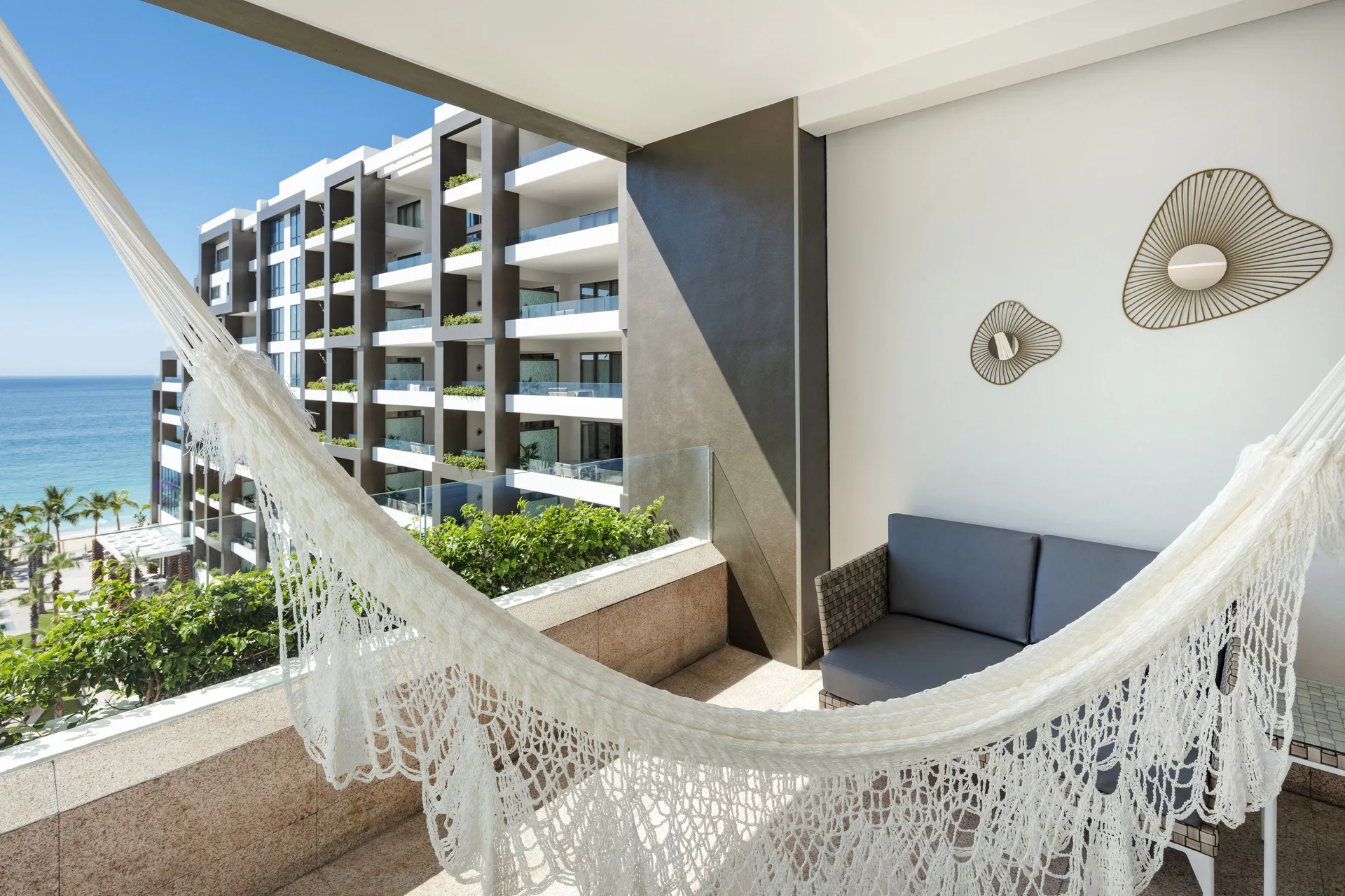 Junior Suite Ocean View balcony hammock overlooking the hotel and sea at Garza Blanca Los Cabos.