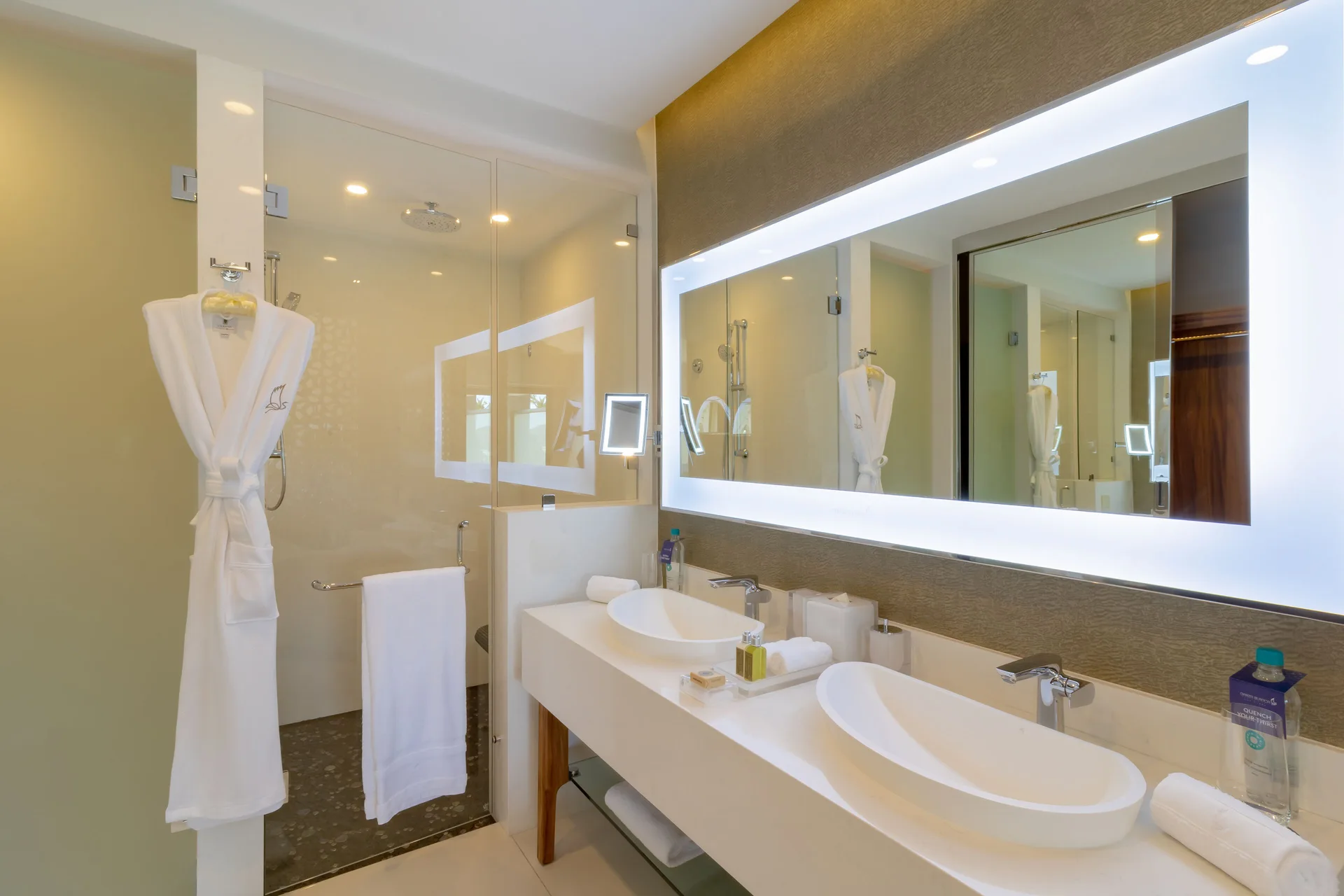 Junior Suite Ocean View bathroom with double sinks and glass shower at Garza Blanca Los Cabos.