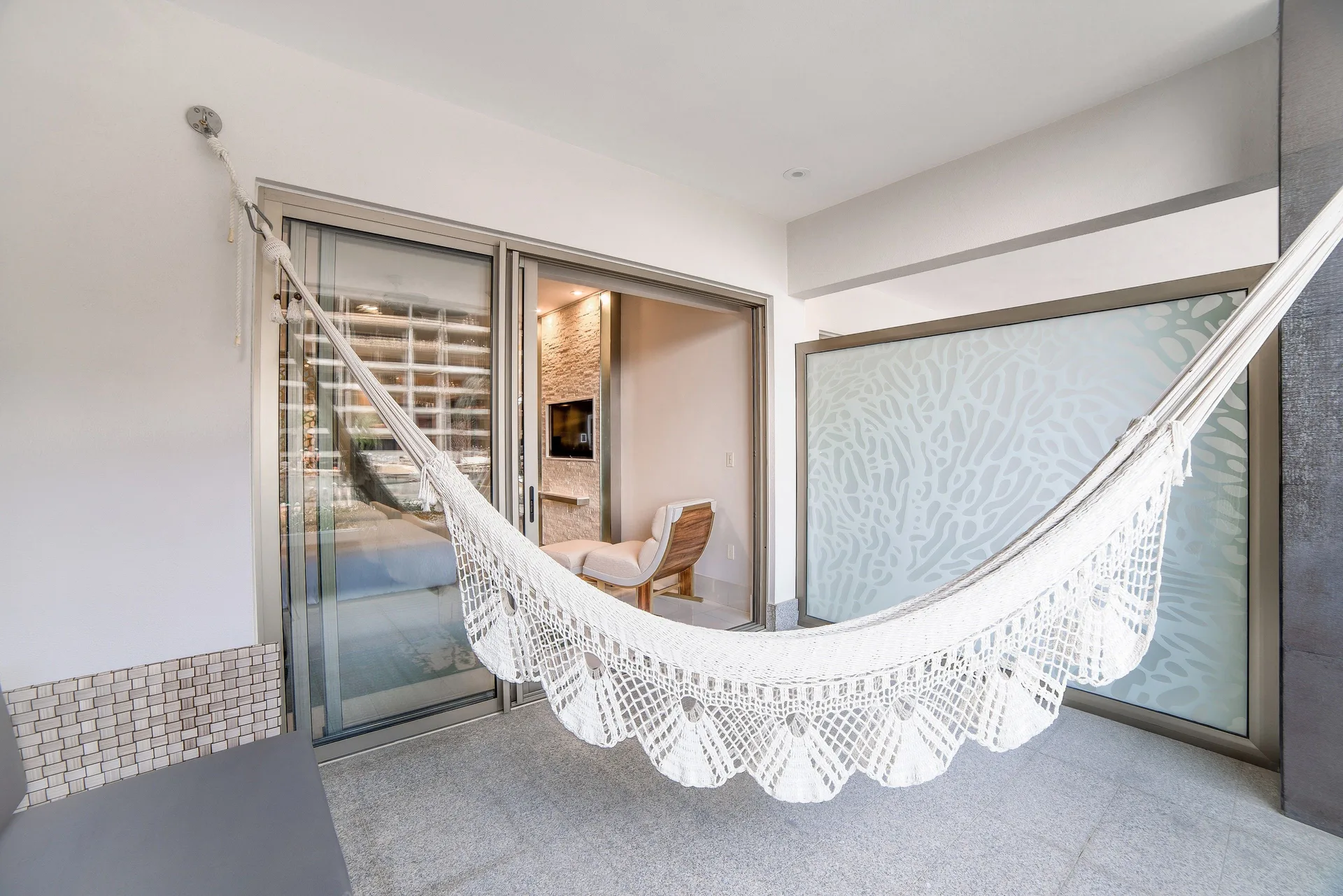 Junior Suite terrace hammock and sliding doors at Garza Blanca Los Cabos.