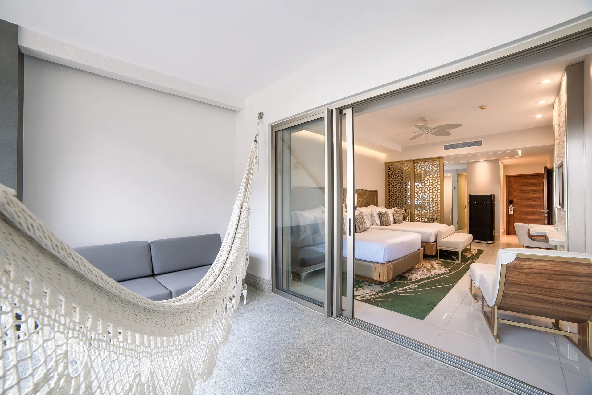 Junior Suite terrace with hammock and seating looking into the room at Garza Blanca Los Cabos.