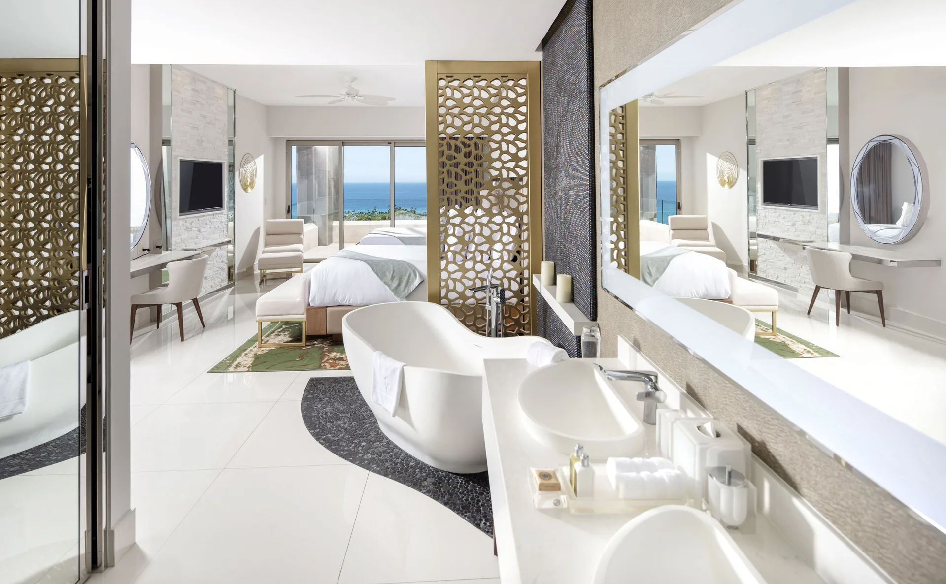 Loft Ocean View bathroom with freestanding tub and bedroom beyond at Garza Blanca Los Cabos.