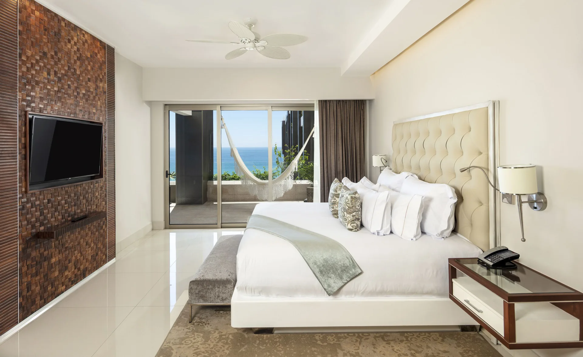 Loft Ocean View bedroom with king bed and terrace hammock at Garza Blanca Los Cabos.