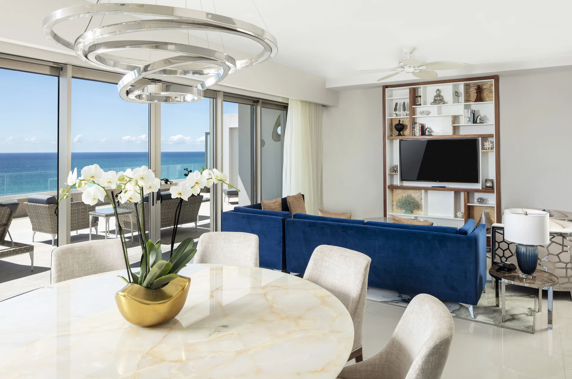 Dining table and living room with ocean view in a 3 Bedroom Suite at Garza Blanca Los Cabos.