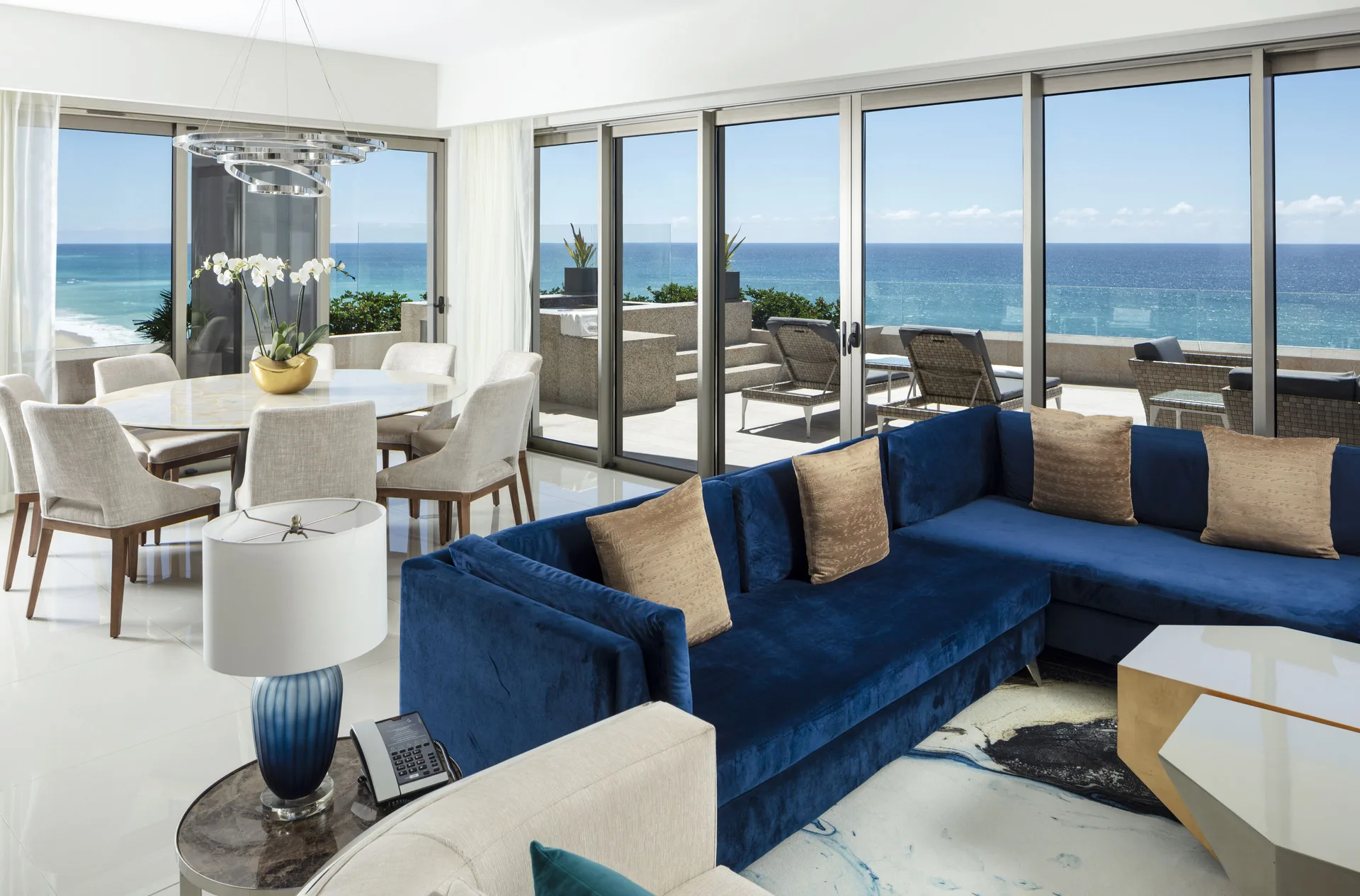 Living and dining area with ocean terrace in a 3 Bedroom Ocean View Suite at Garza Blanca Los Cabos.