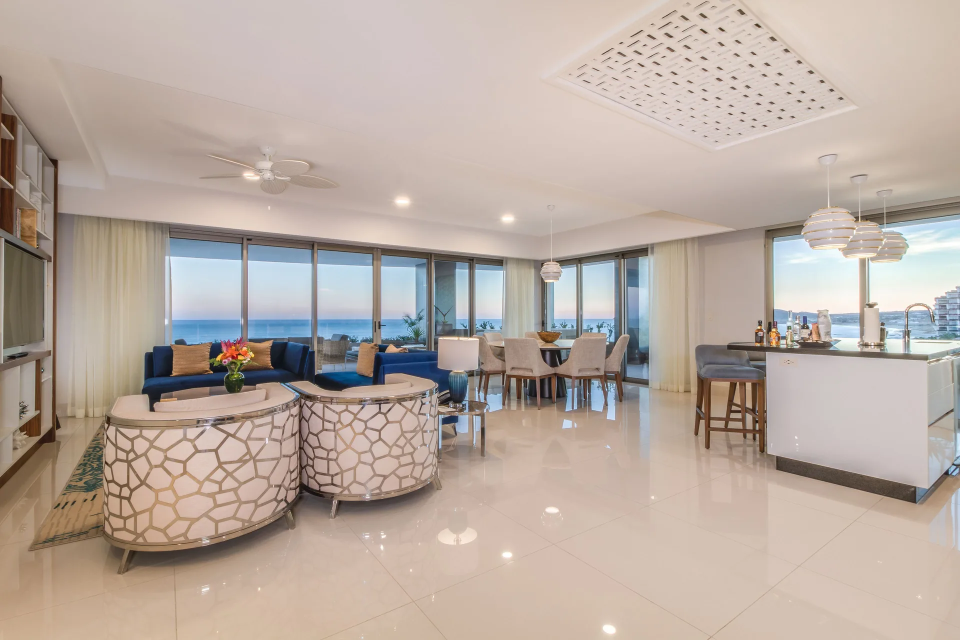 Open living, dining and kitchen area in an ocean-view suite at Garza Blanca Los Cabos.