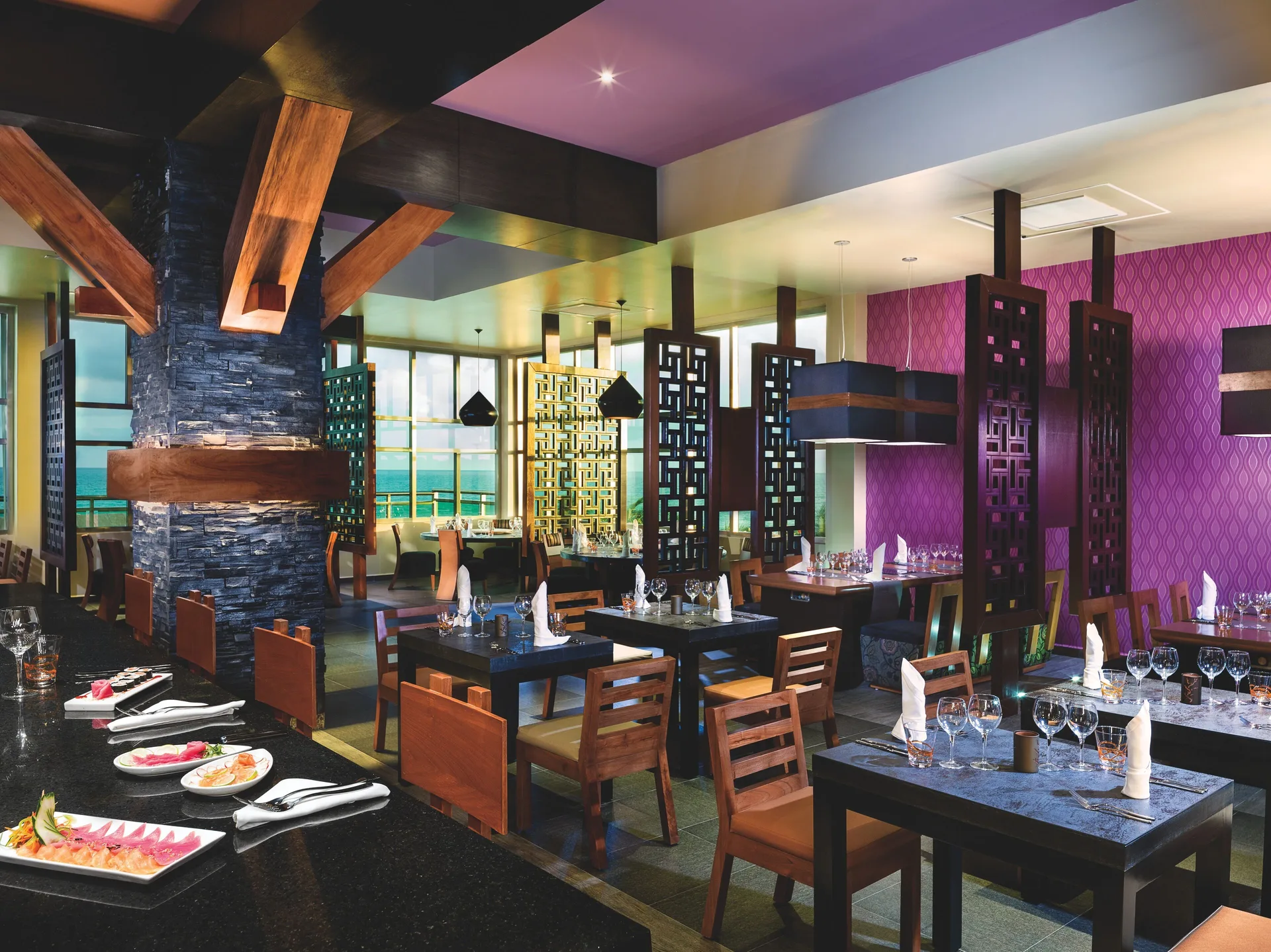 Pan-Asian style dining room with dark tables at Generations Riviera Maya.