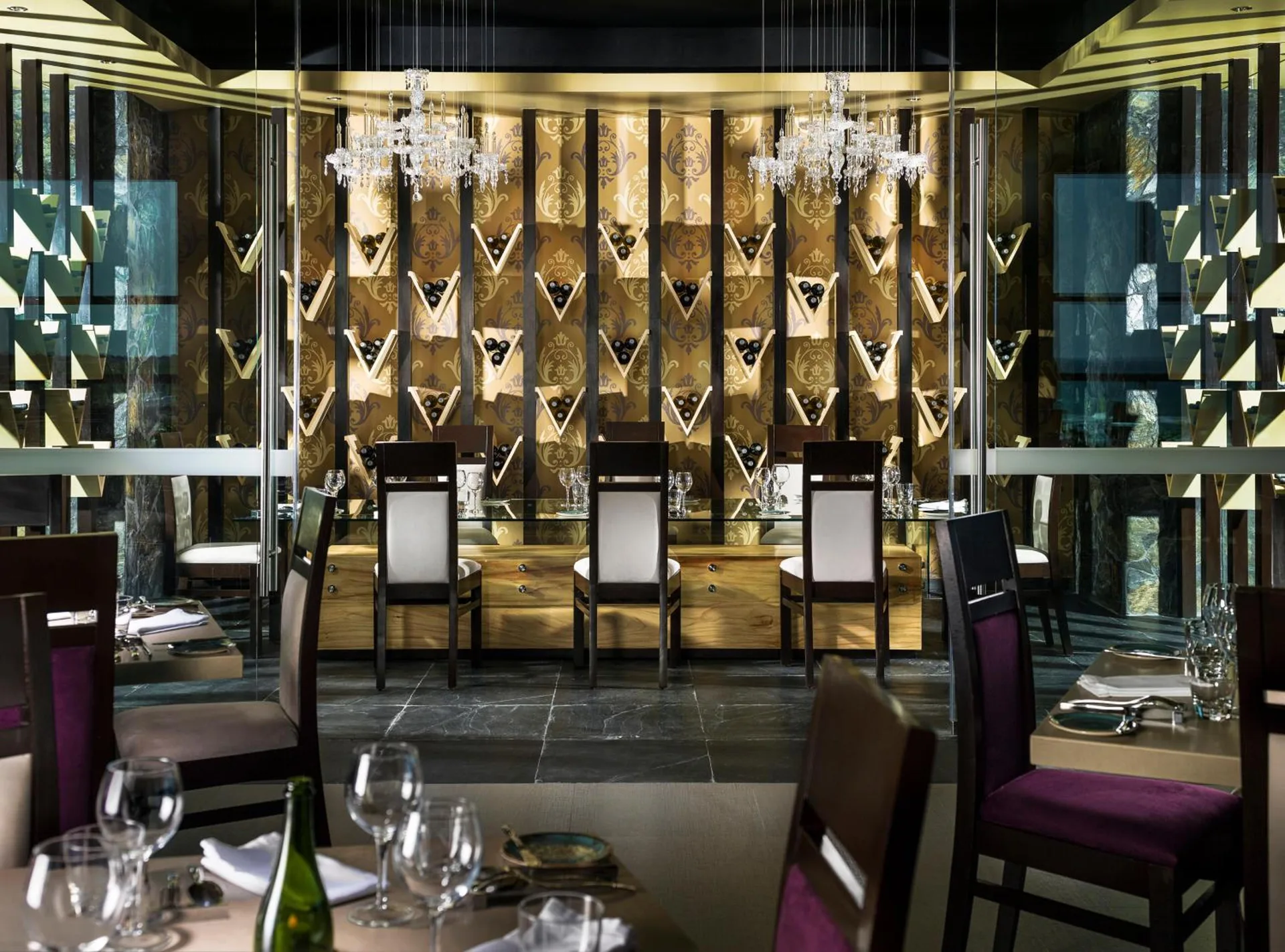 Wine display dining room with chandeliers at Generations Riviera Maya.