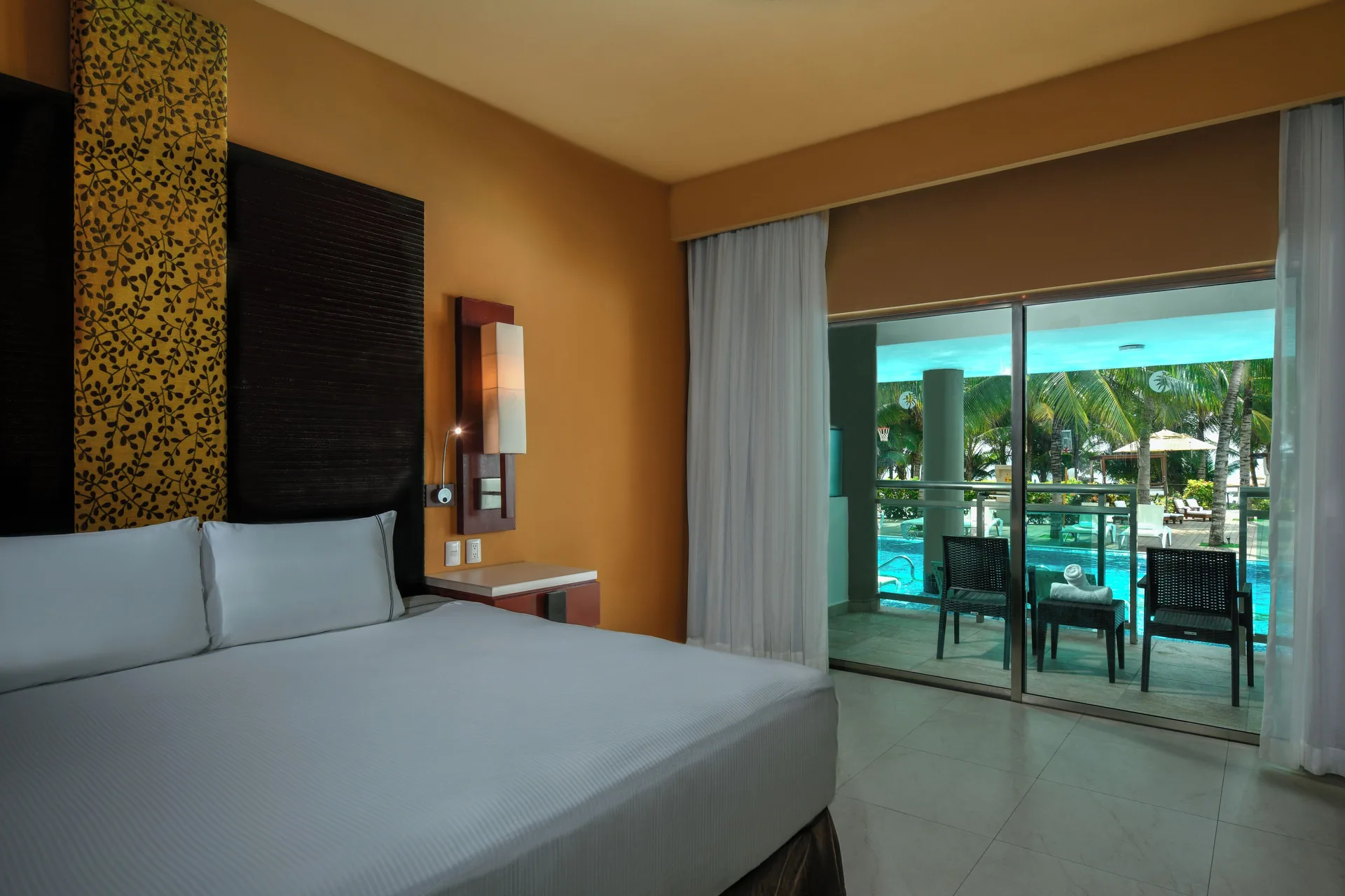 Oceanfront Pool Swim Up Suite king bed and balcony at Generations Riviera Maya.