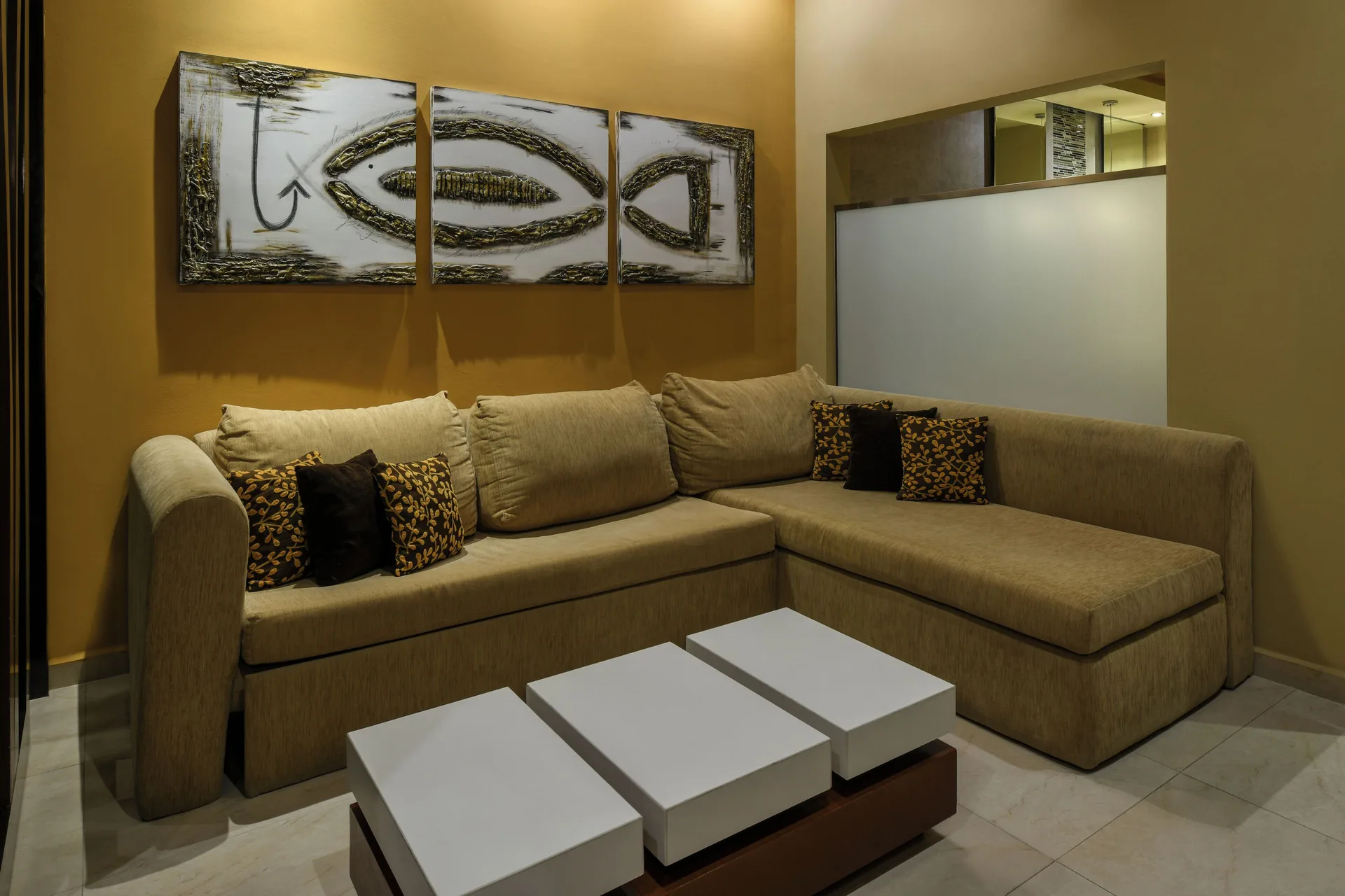 Oceanfront Suite sitting area at Generations Riviera Maya with sectional sofa and wall art.