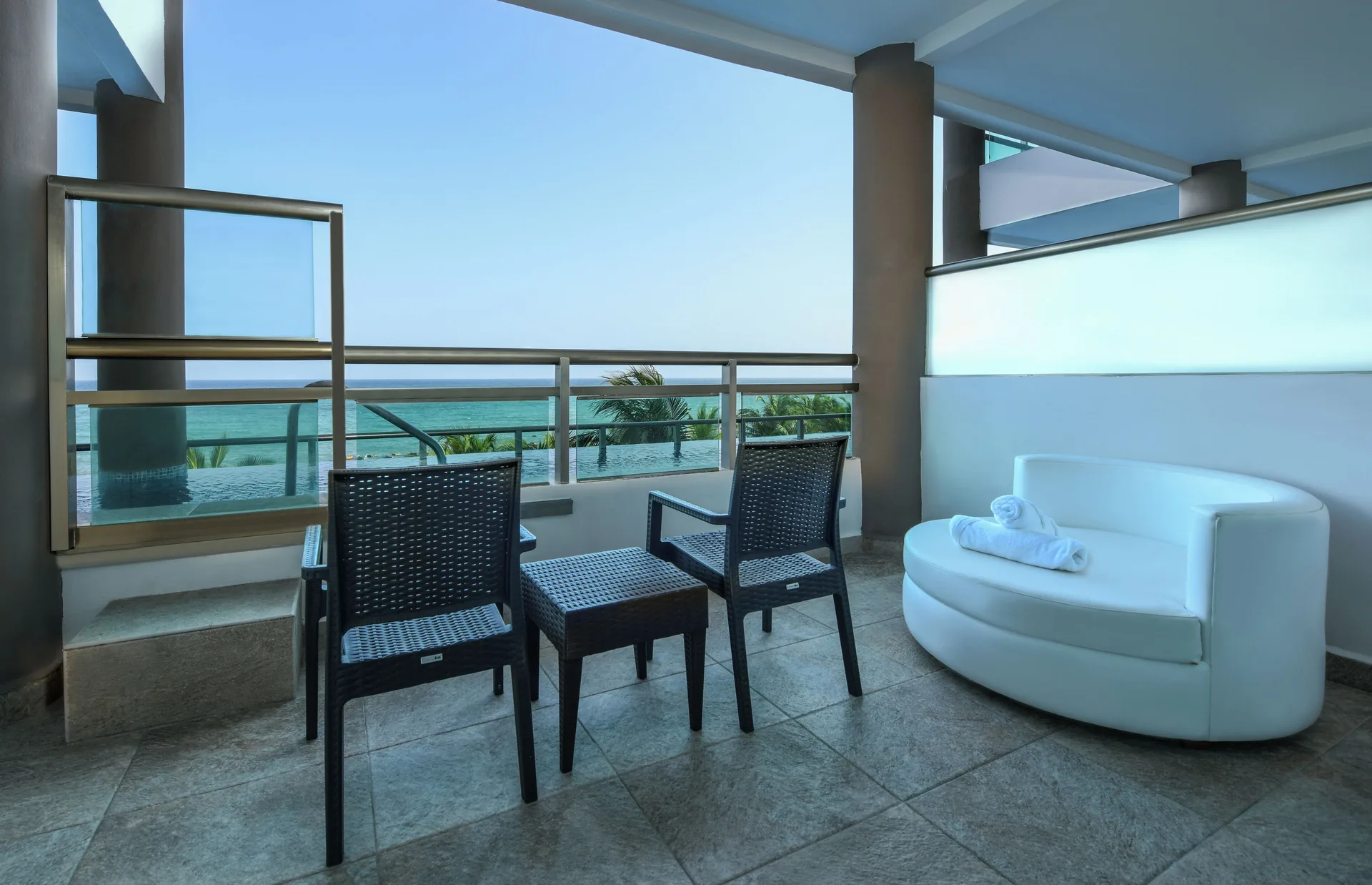 Oceanfront Swim Up Suite terrace with seating and pool access at Generations Riviera Maya.