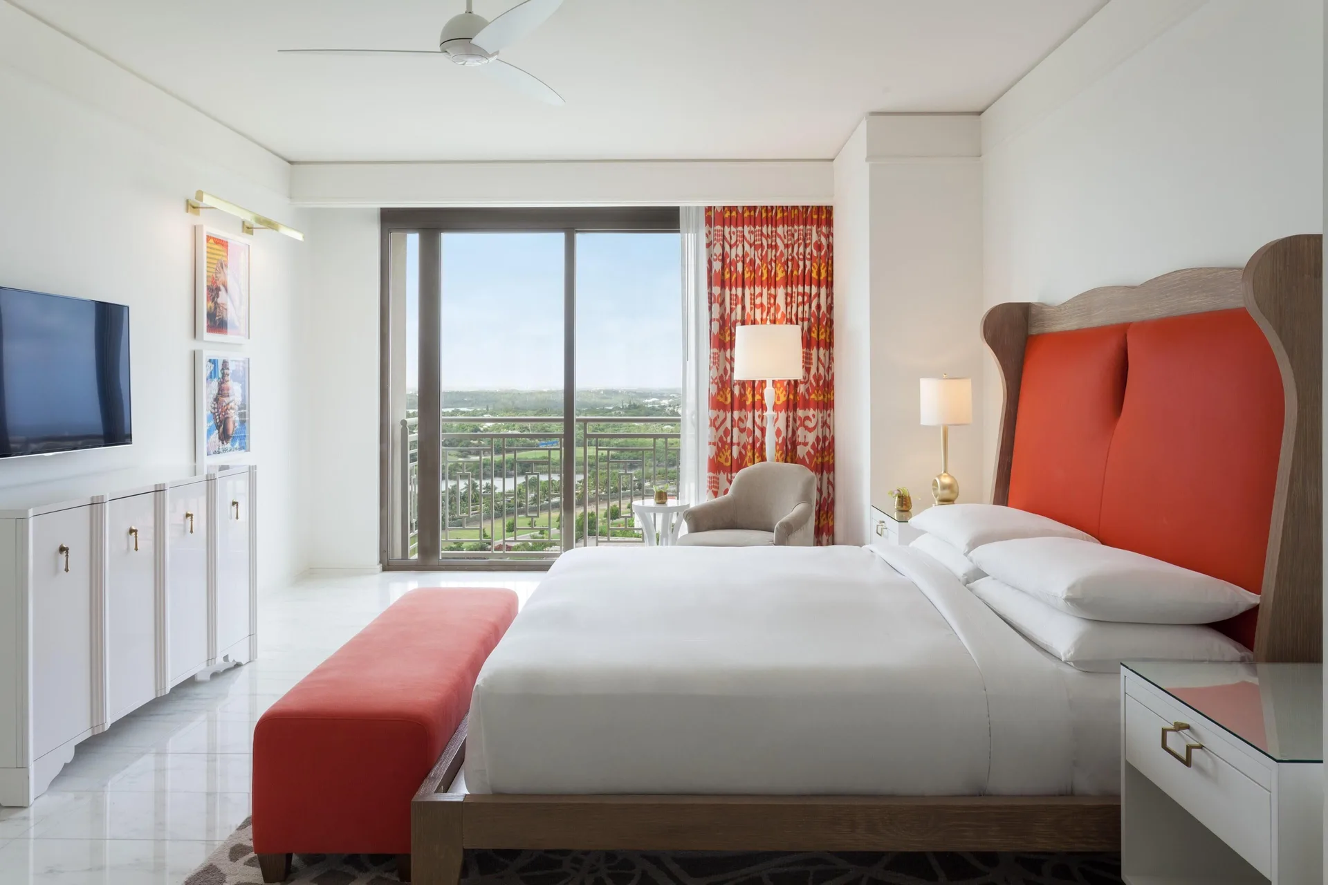 King guest room with red headboard and balcony view at Grand Hyatt Baha Mar.