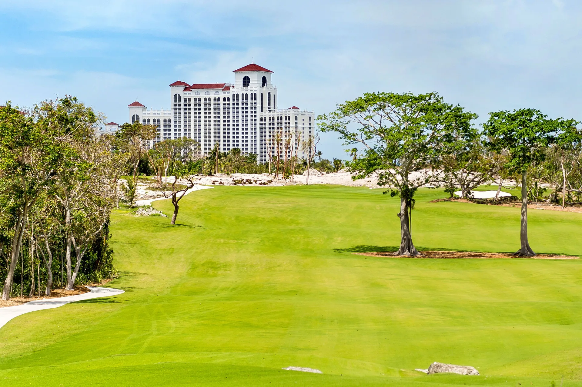 A wide golf fairway leads toward resort towers at Grand Hyatt Baha Mar.