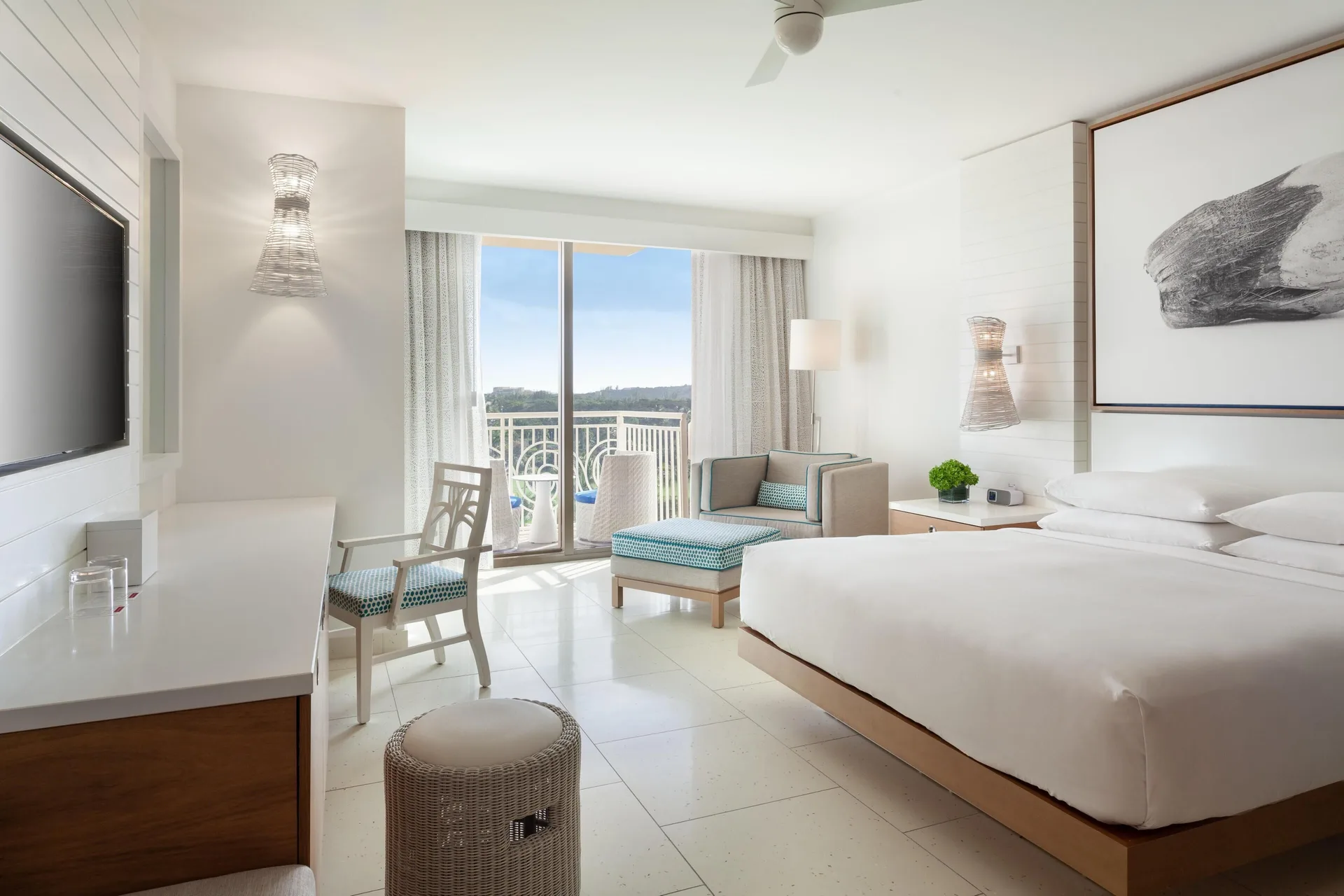 King guest room with balcony, desk, and lounge chair at Grand Hyatt Baha Mar.