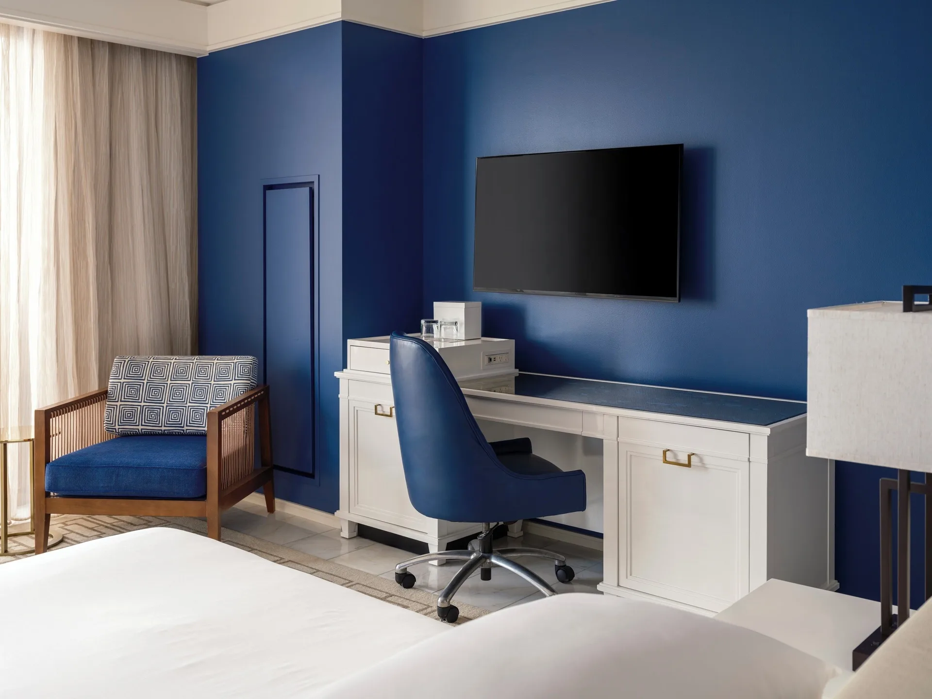 Guest room desk, blue accent wall, and seating at Grand Hyatt Baha Mar.