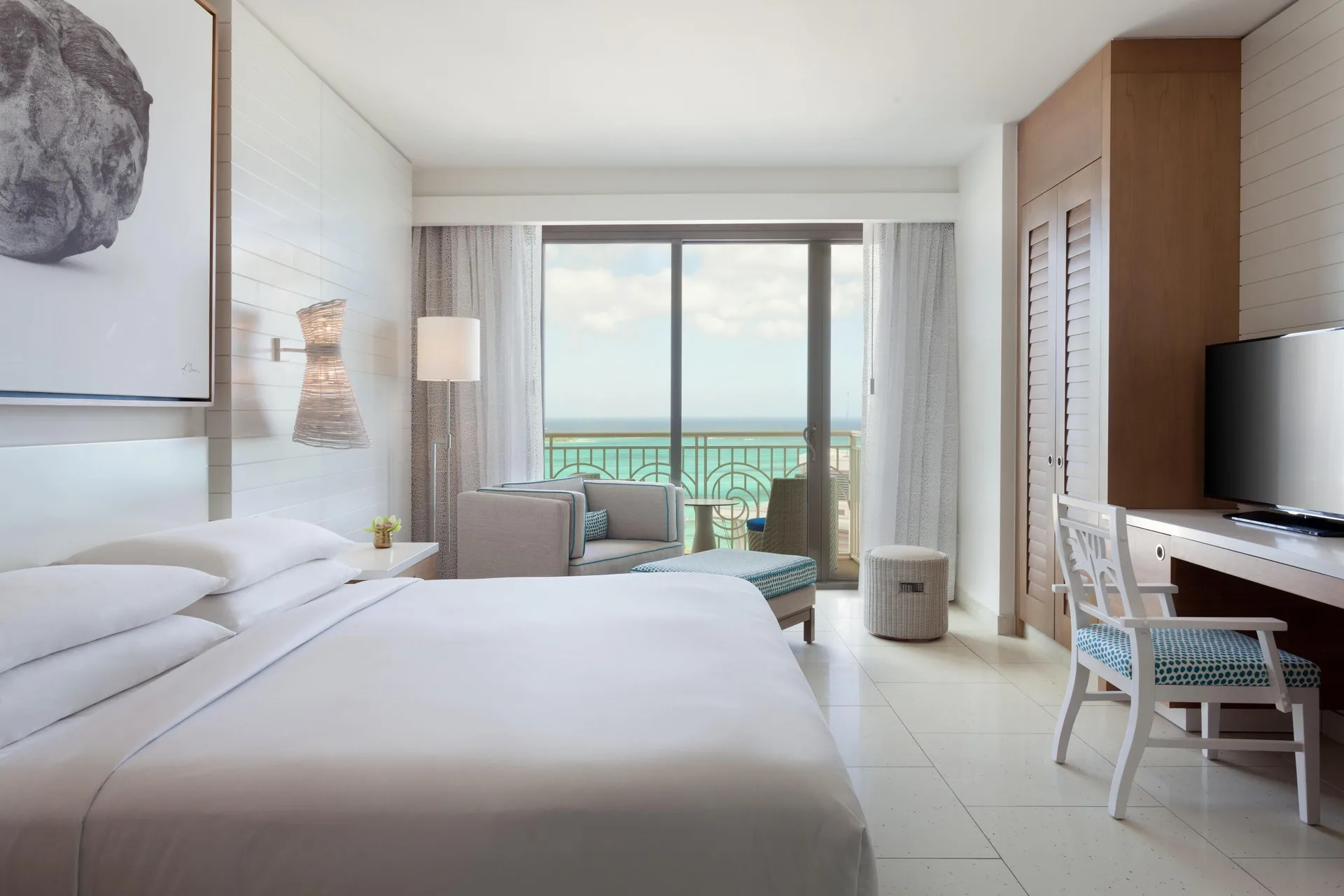 Ocean-view king guest room with desk and balcony at Grand Hyatt Baha Mar.