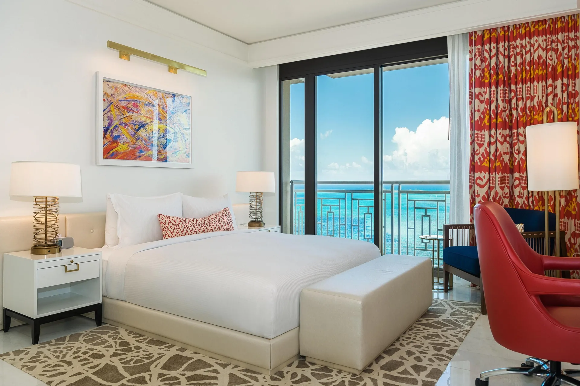 Ocean-view king room with red chair and balcony at Grand Hyatt Baha Mar.