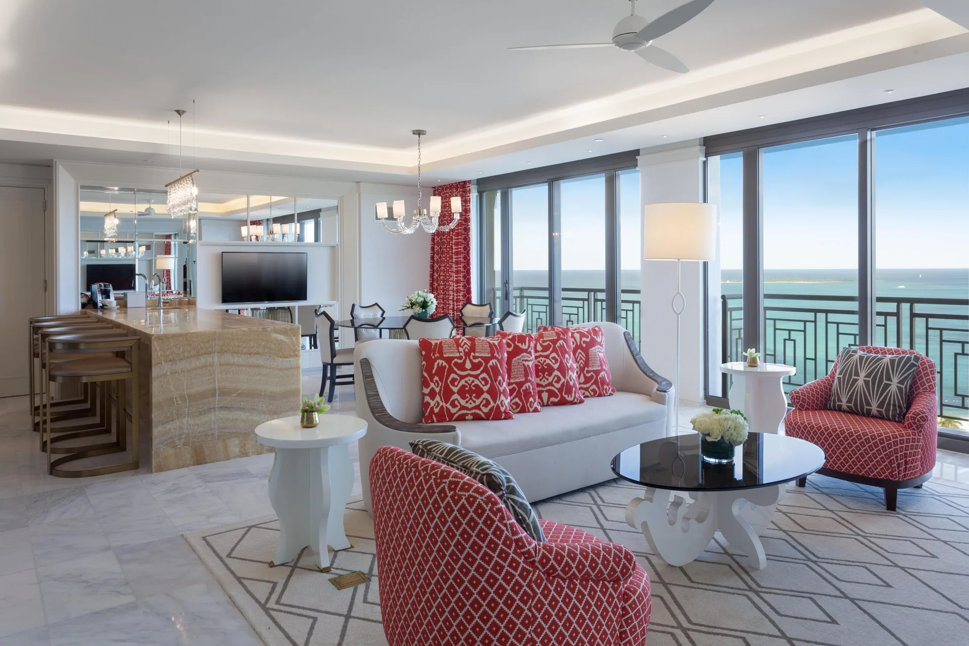 Oceanfront suite living room with red chairs at Grand Hyatt Baha Mar.