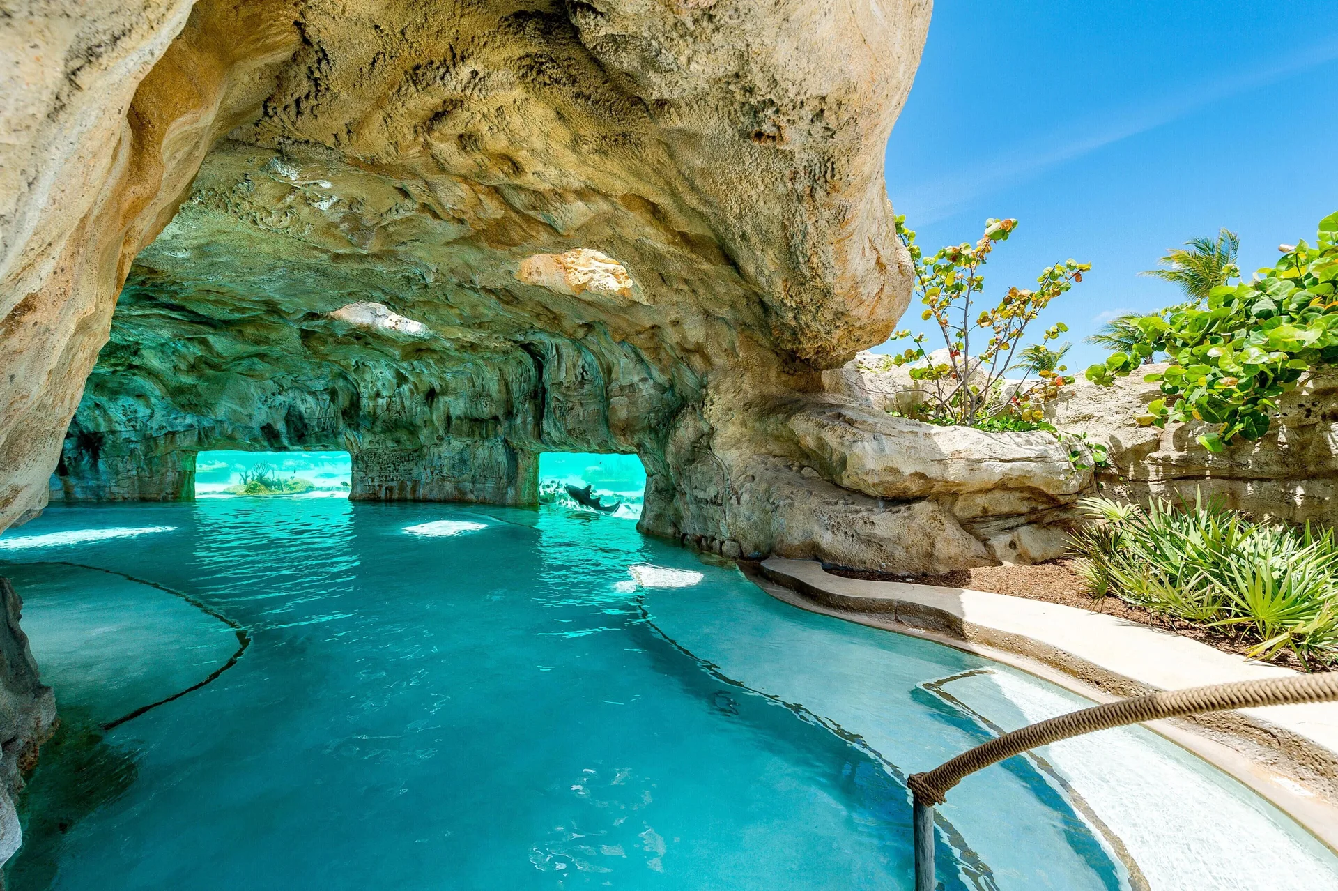 Rock grotto pool with turquoise water at Grand Hyatt Baha Mar.