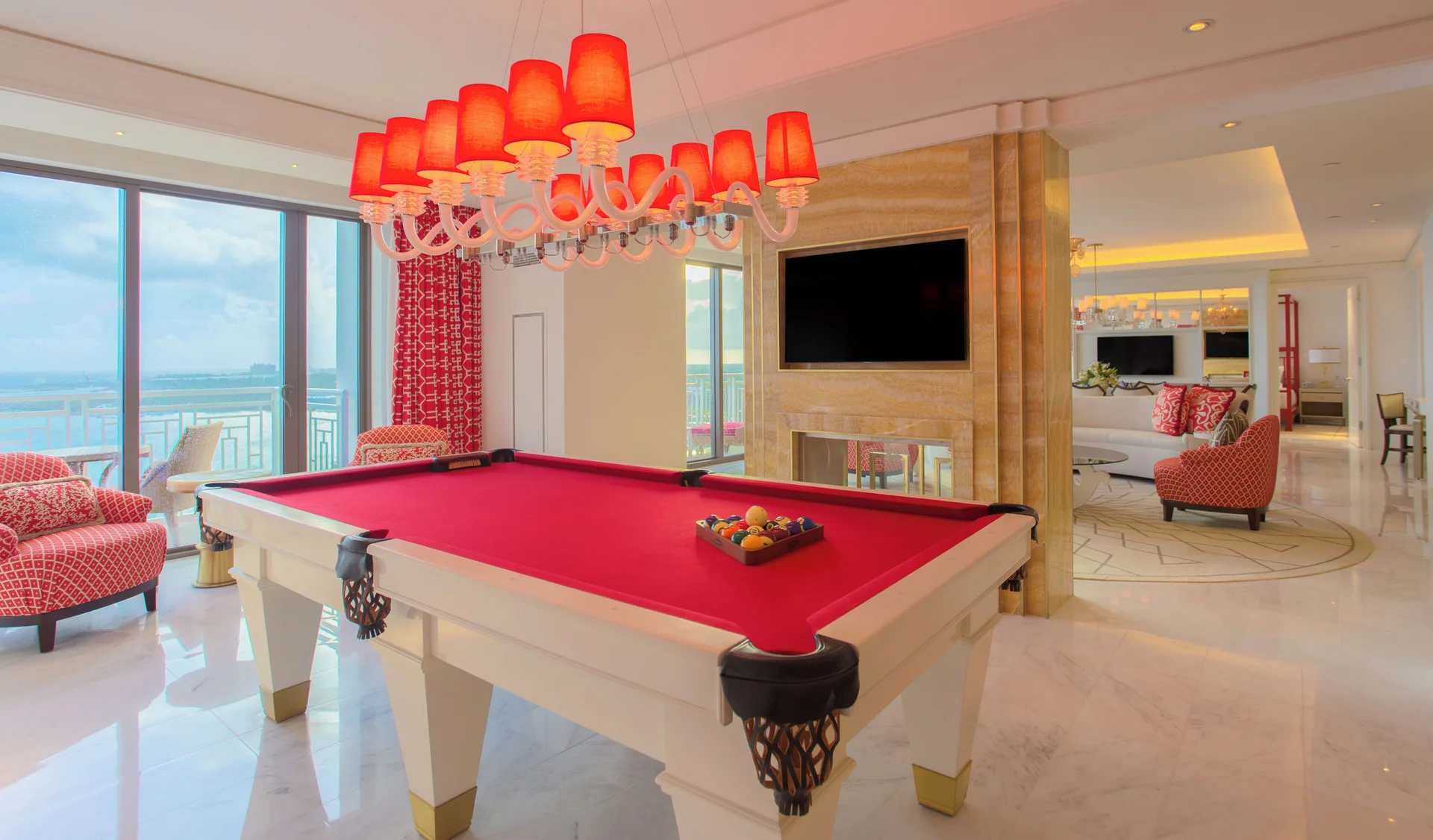 Suite game room with red pool table beside balcony windows at Grand Hyatt Baha Mar.