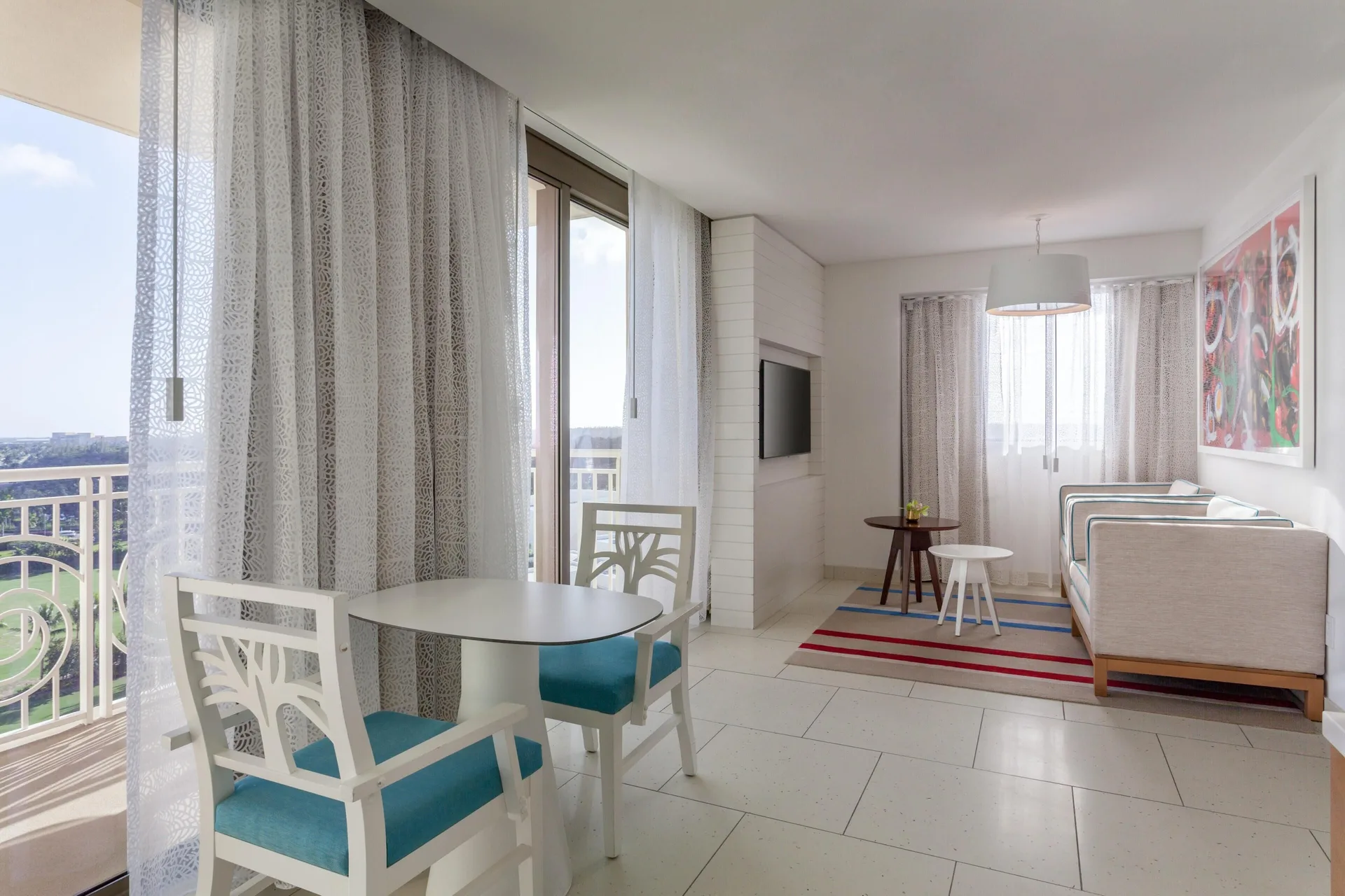 Suite living area with balcony dining table at Grand Hyatt Baha Mar.