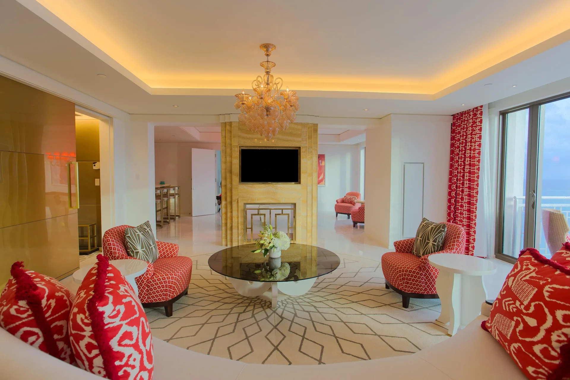 Suite lounge with patterned red seating and ocean balcony at Grand Hyatt Baha Mar.