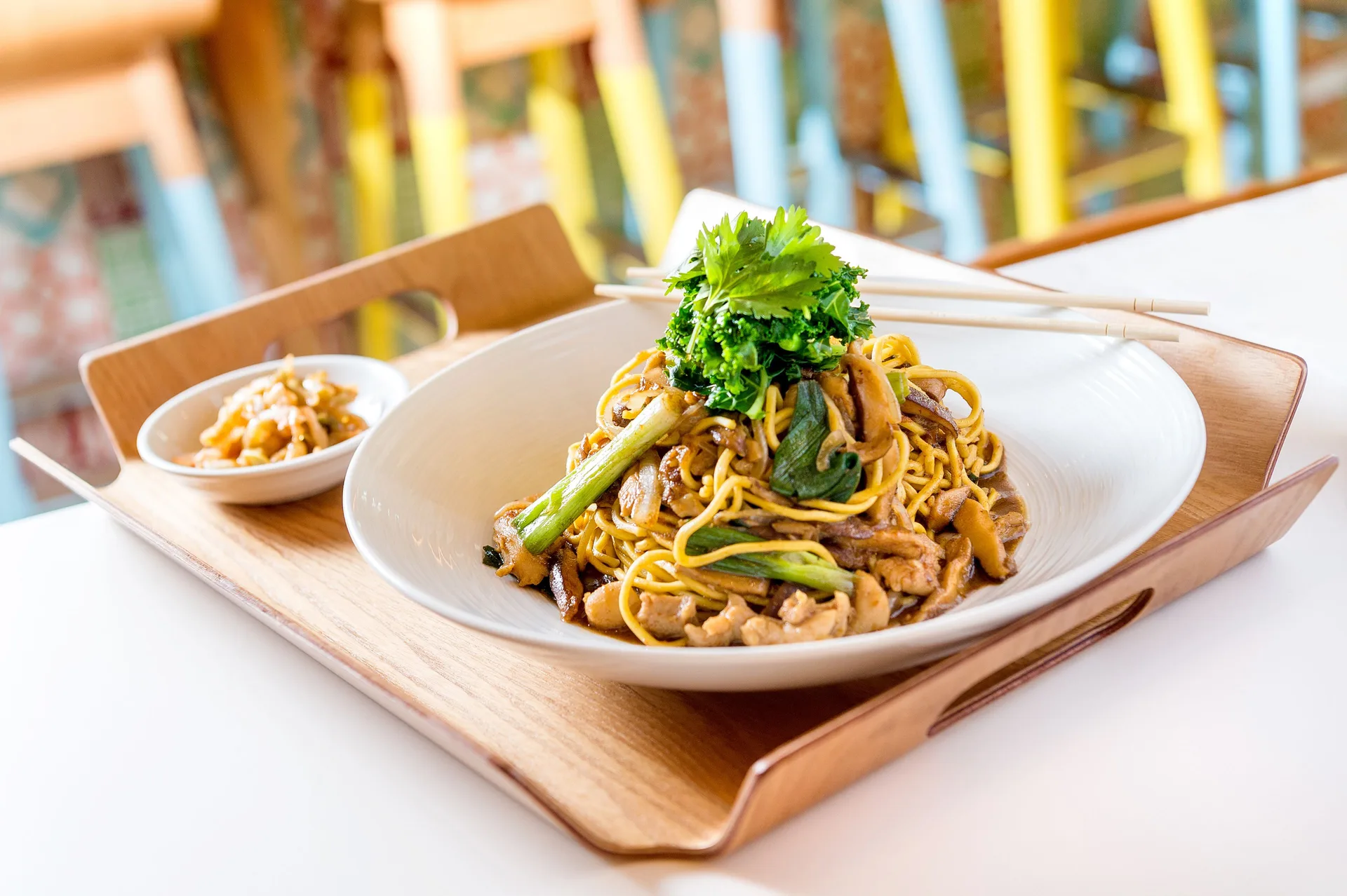 Noodle dish on a wooden tray with chopsticks at Grand Hyatt Baha Mar.