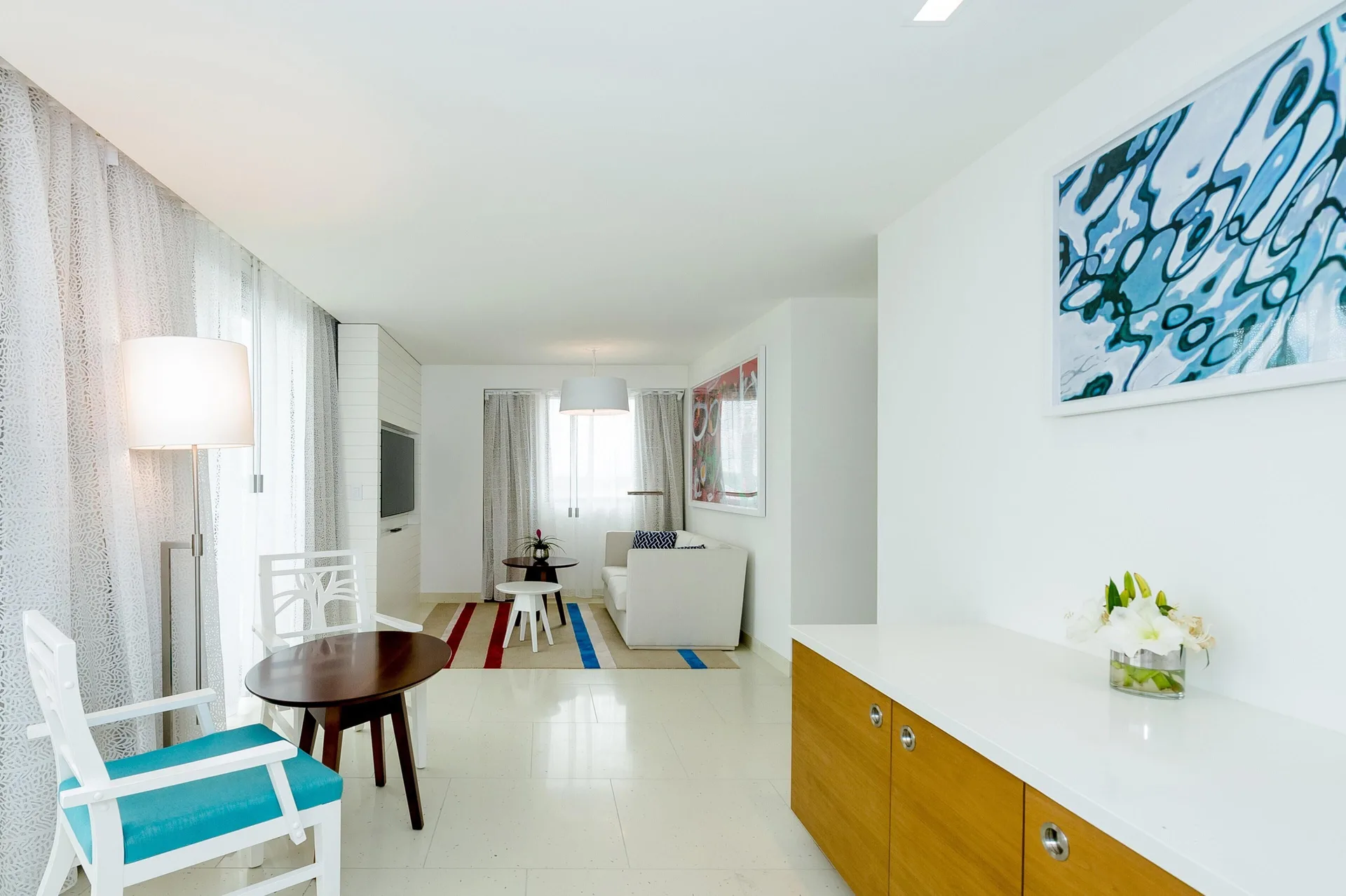 Grand Suite living area with chairs, sofa, artwork, and console at Grand Hyatt Baha Mar.