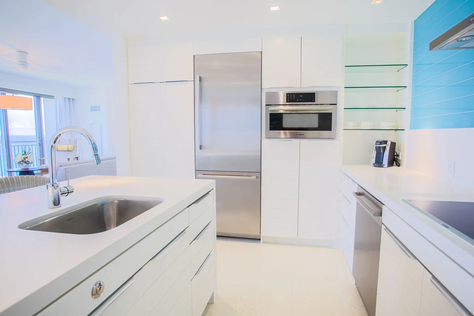 Residence kitchen with stainless appliances and ocean glimpse at Grand Hyatt Baha Mar.