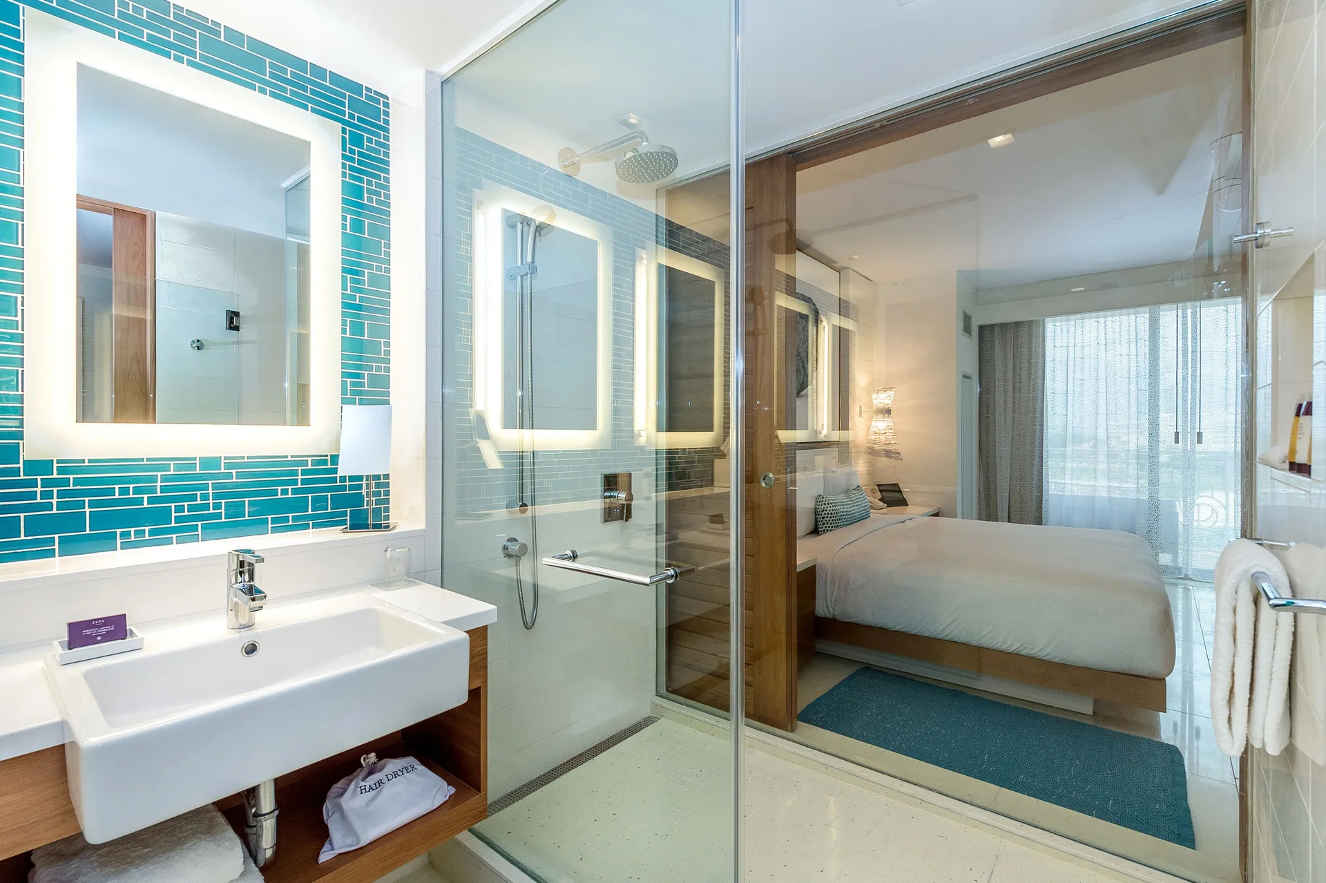 Bathroom vanity and glass shower beside the bedroom at Grand Hyatt Baha Mar.