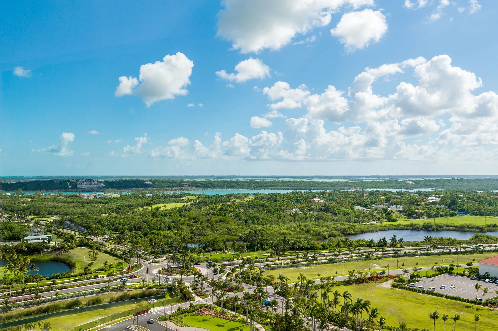 Daytime balcony view over greenery and water from Grand Hyatt Baha Mar.