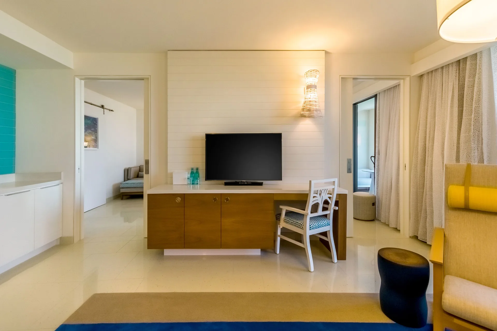Living area with TV, desk, and bedroom doorways in a residence at Grand Hyatt Baha Mar.