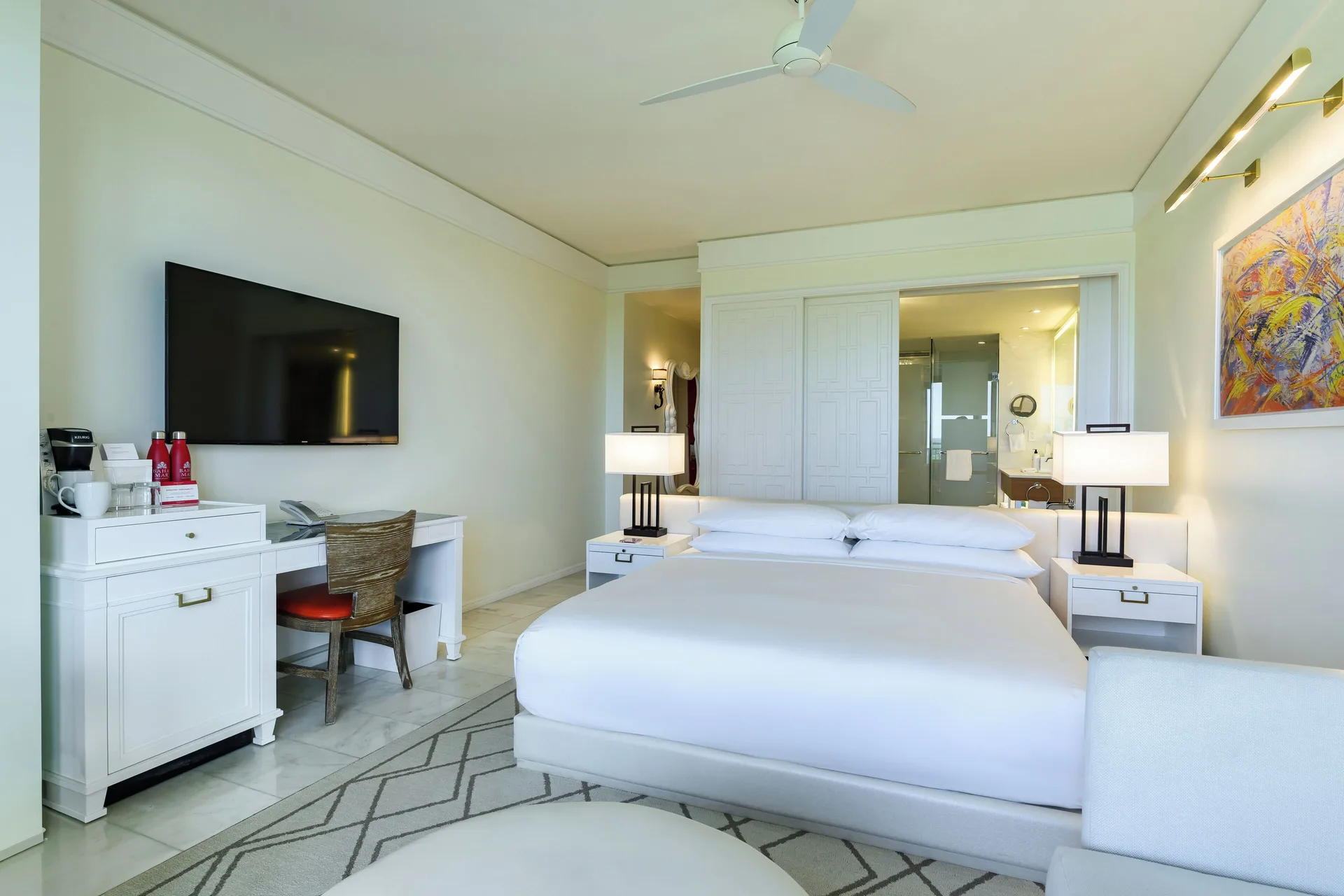 Fountain View Reserve king bed with desk and TV at Grand Hyatt Baha Mar.