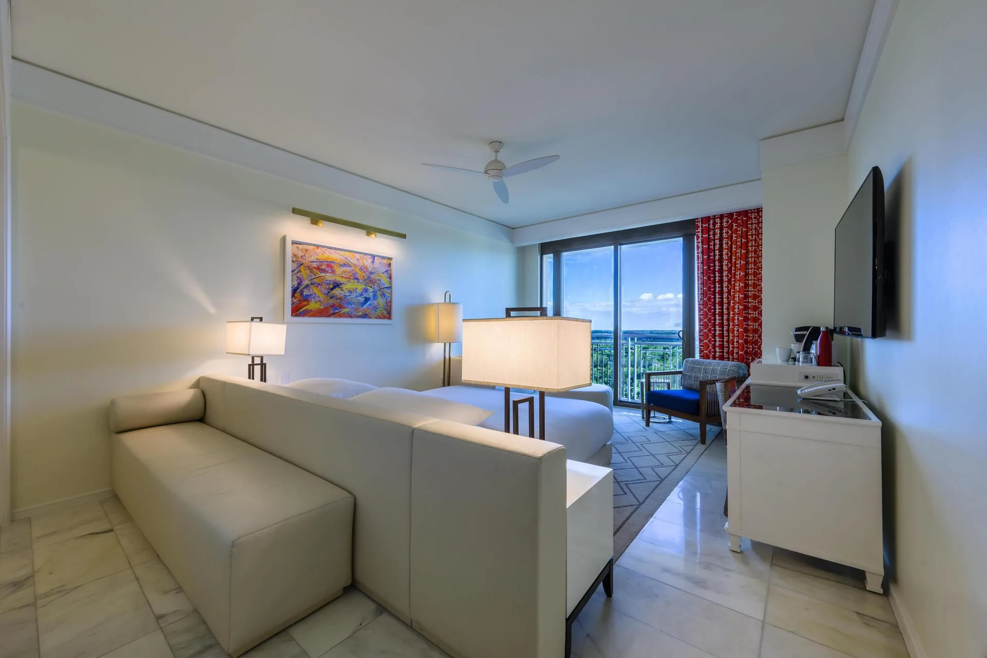 Fountain View Reserve room with sofa, bed, balcony, and TV at Grand Hyatt Baha Mar.