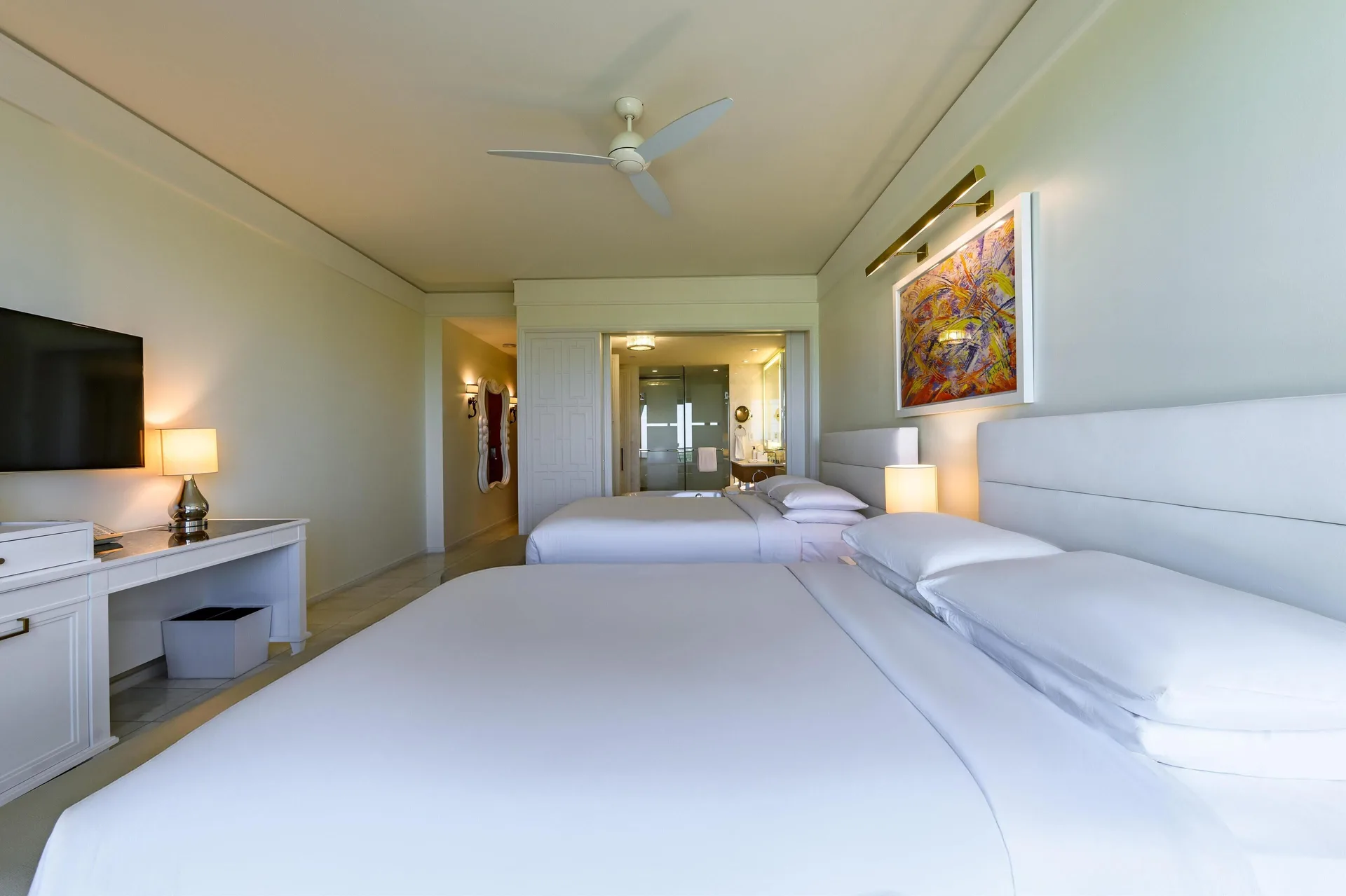 Two queen beds and open bath area in a guest room at Grand Hyatt Baha Mar.