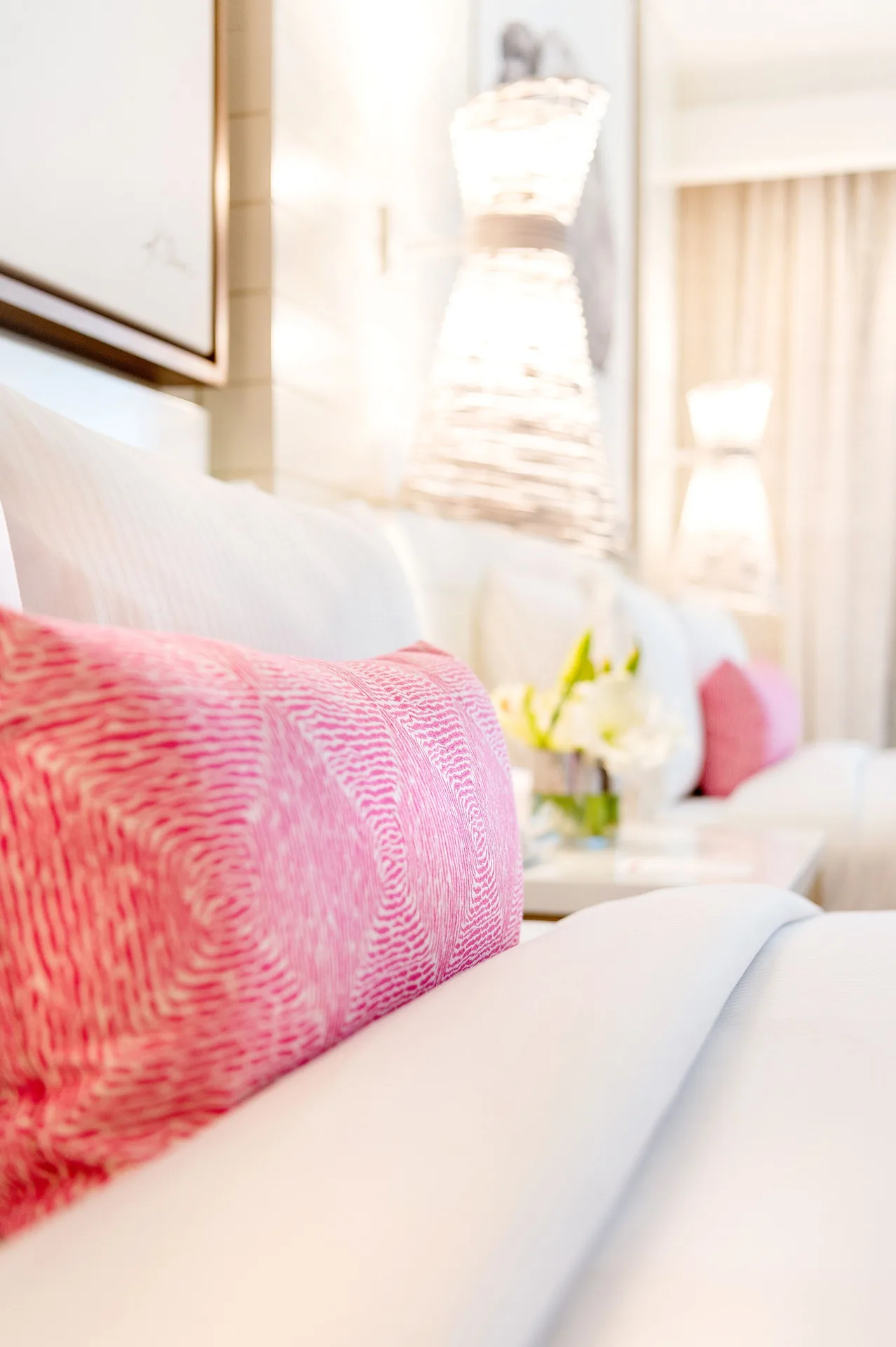 Close-up of a pink pillow on a white bed in a room at Grand Hyatt Baha Mar.