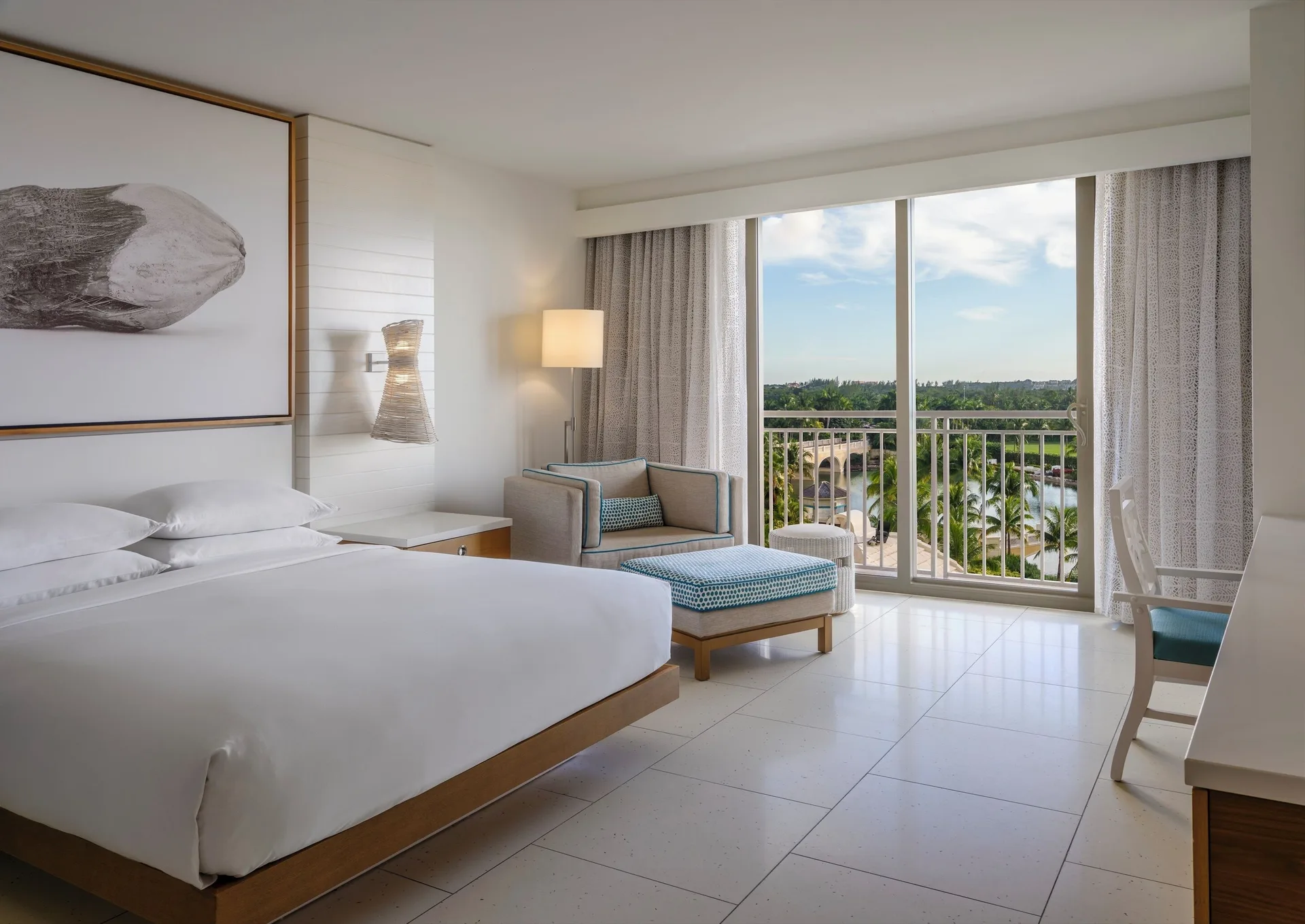 King bed room with balcony doors and fountain view at Grand Hyatt Baha Mar.
