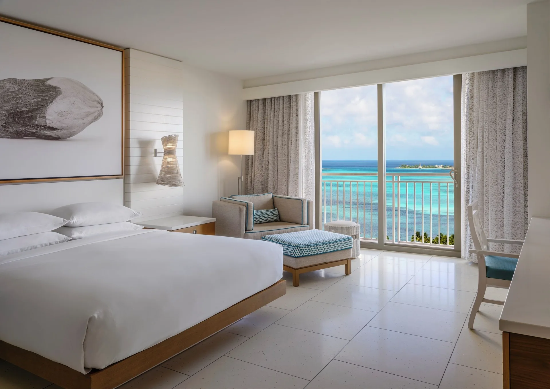 Ocean View king room with armchair, ottoman, and balcony at Grand Hyatt Baha Mar.