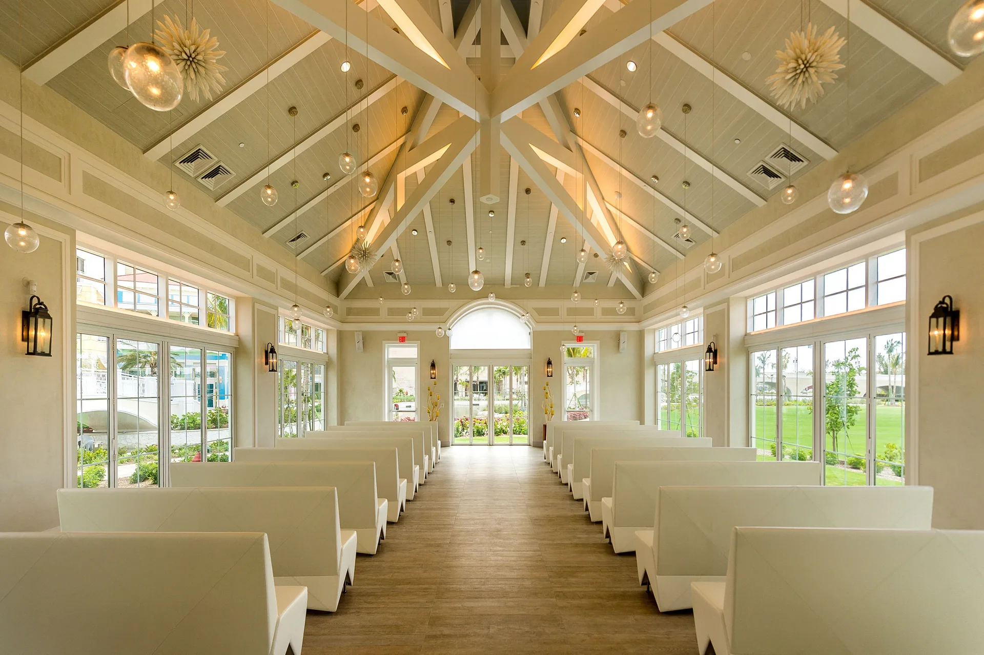 White chapel-style event room with benches and vaulted ceiling at Grand Hyatt Baha Mar.