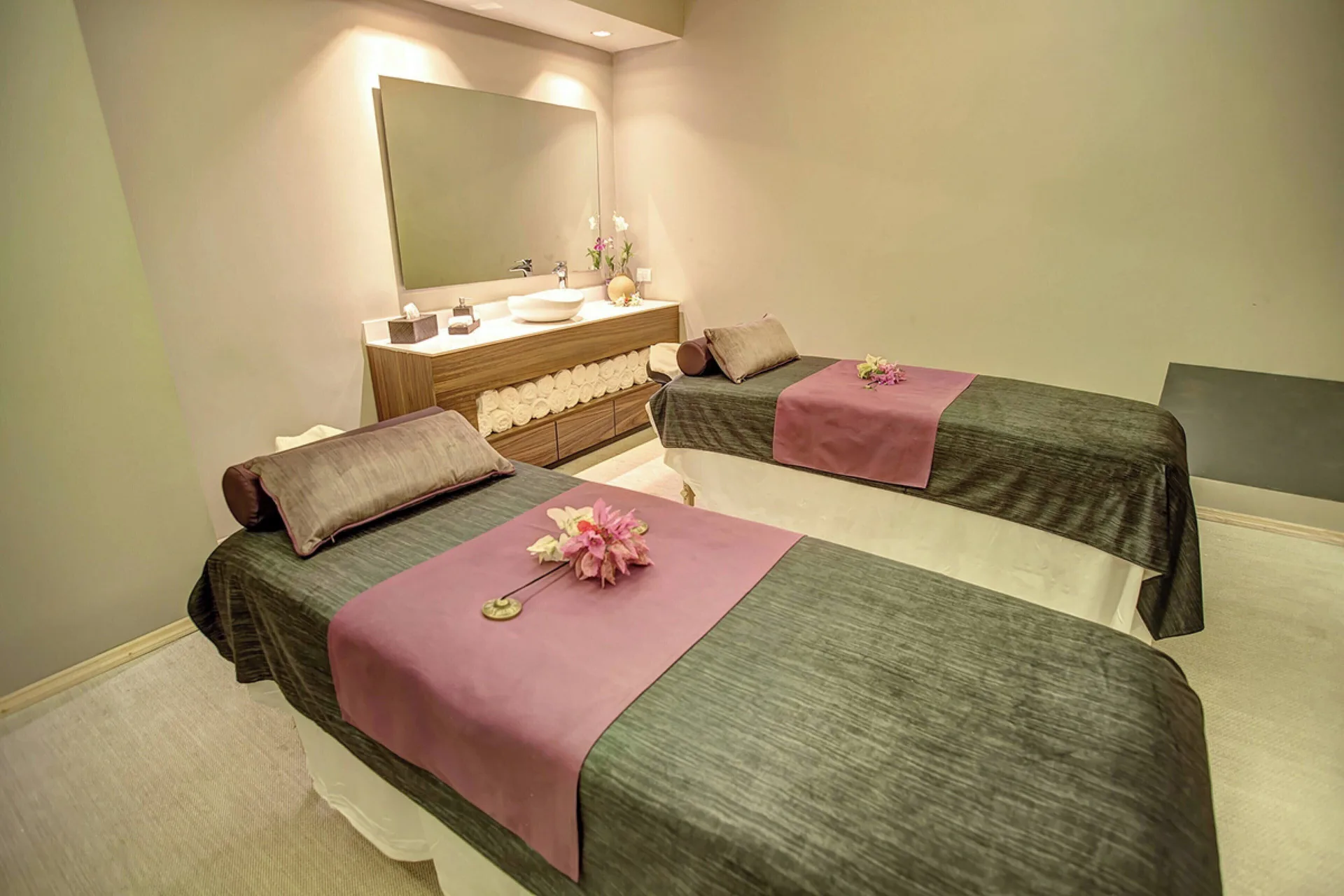 Two spa treatment beds with floral accents at Grand Lido Negril Au-Naturel.