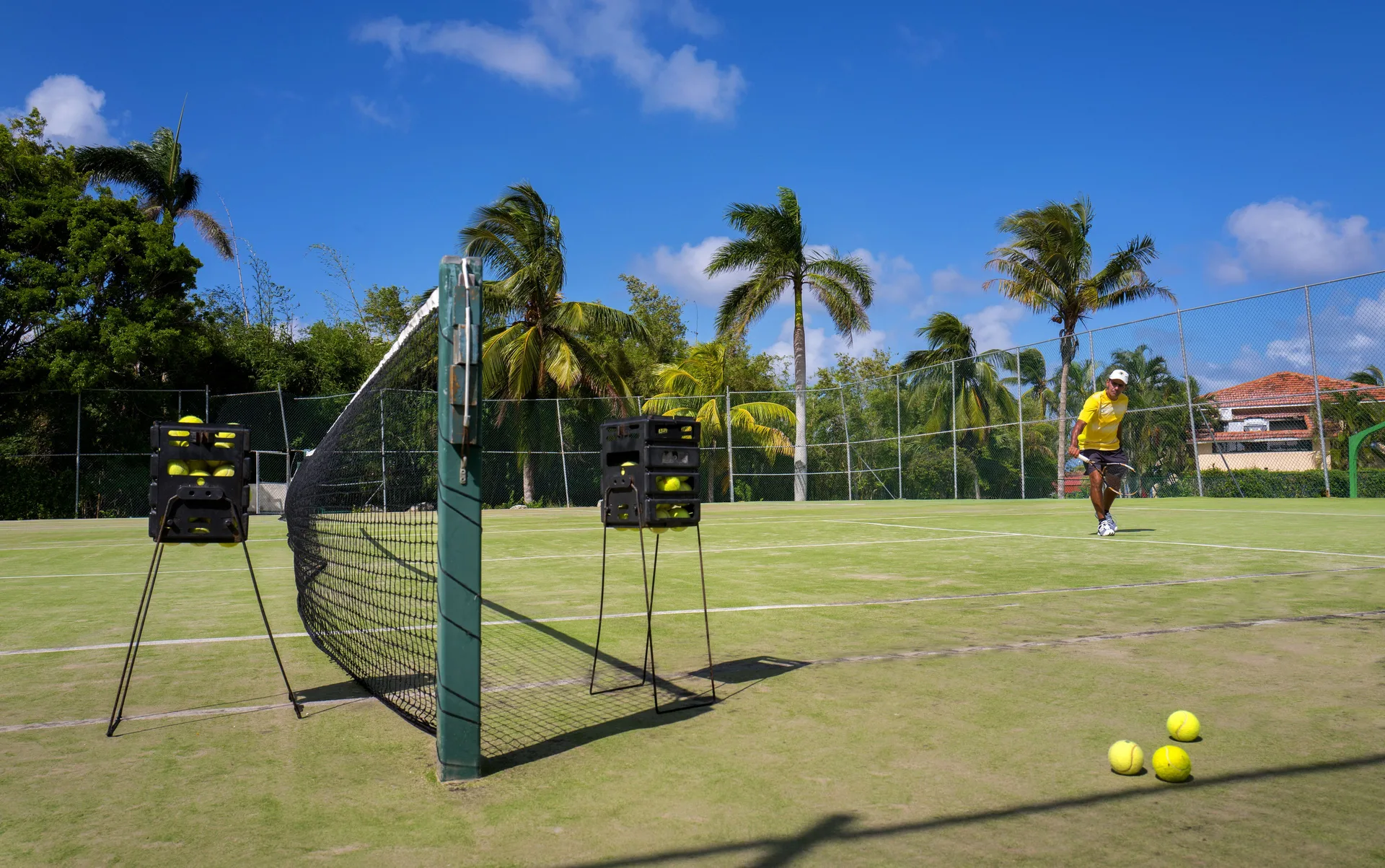 Tennis court with practice ball baskets at Grand Lido Negril Au-Naturel.