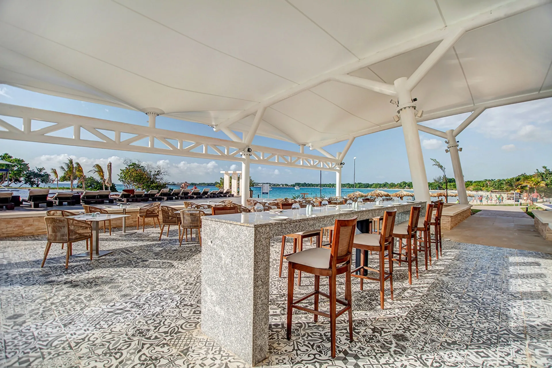 Open-air beachside bar seating at Grand Lido Negril Au-Naturel.