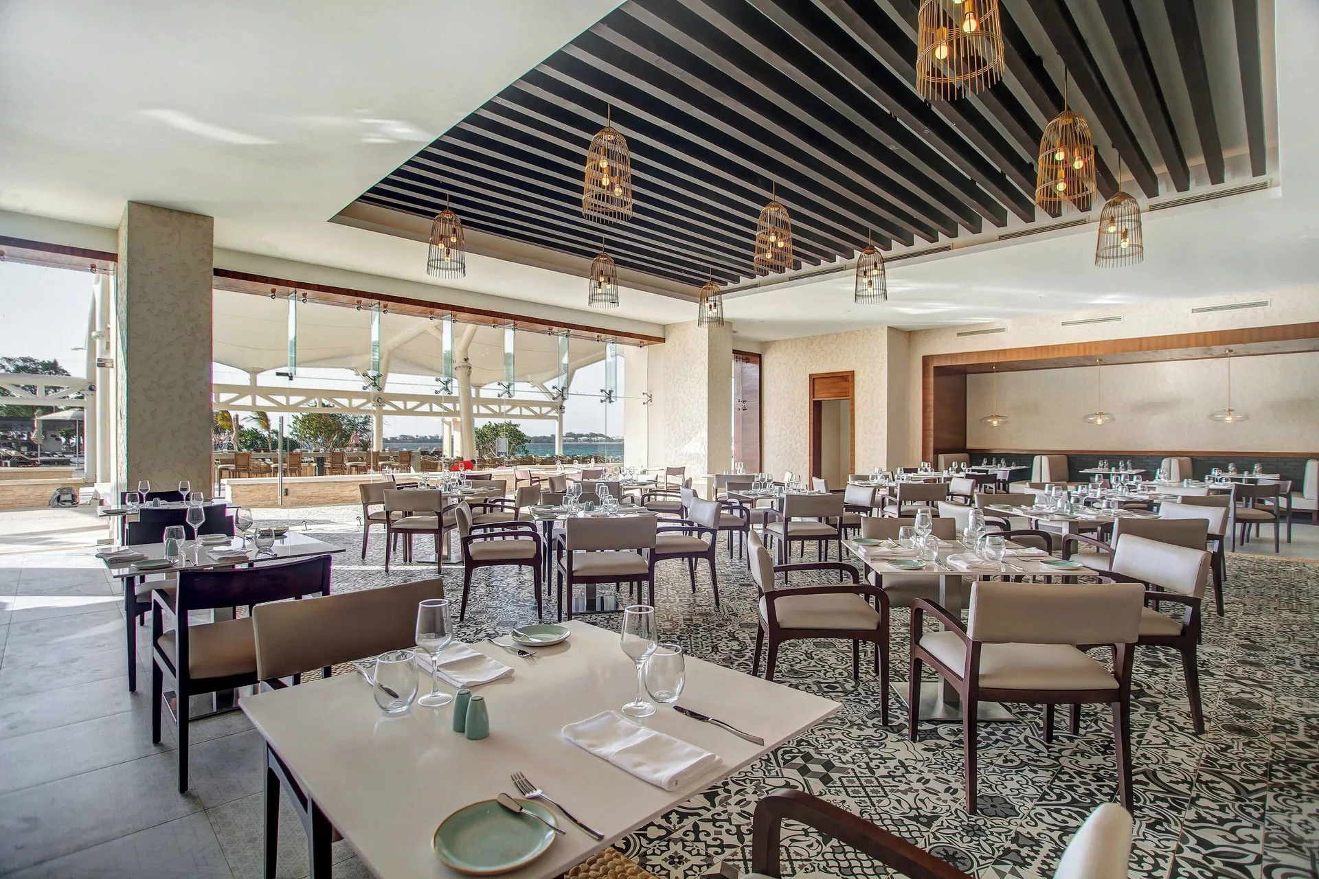 Open-air restaurant dining room with ocean beyond at Grand Lido Negril Au-Naturel.